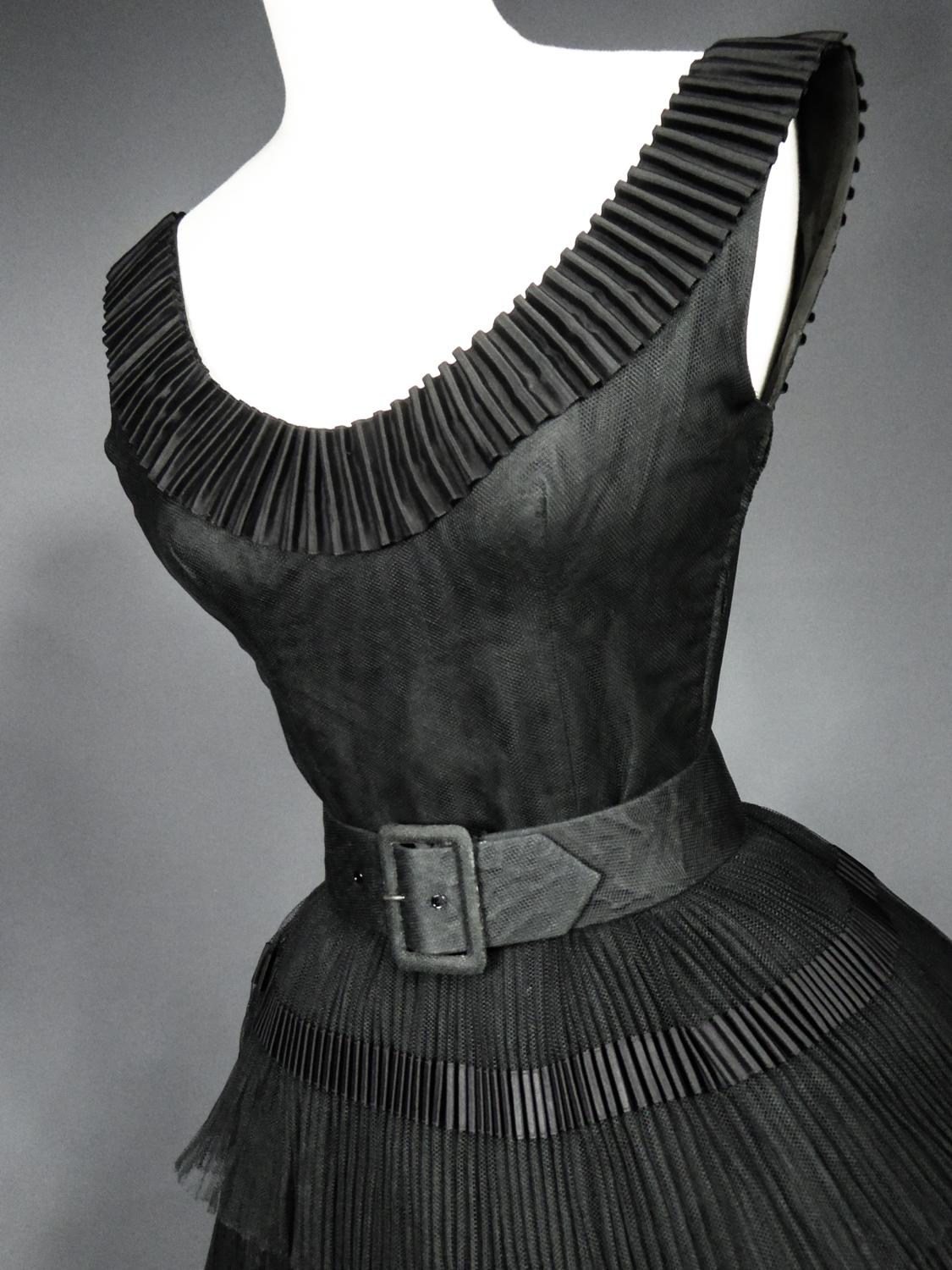 Circa 1958/1962
France

Astonishing Little Cocktail Black Dress composed of 3 pieces : bodice, skirt and belt by Nina Ricci Haute Couture dating from the end of the 1950s. Sleeveless bodice with large cleavage in black taffeta covered with black