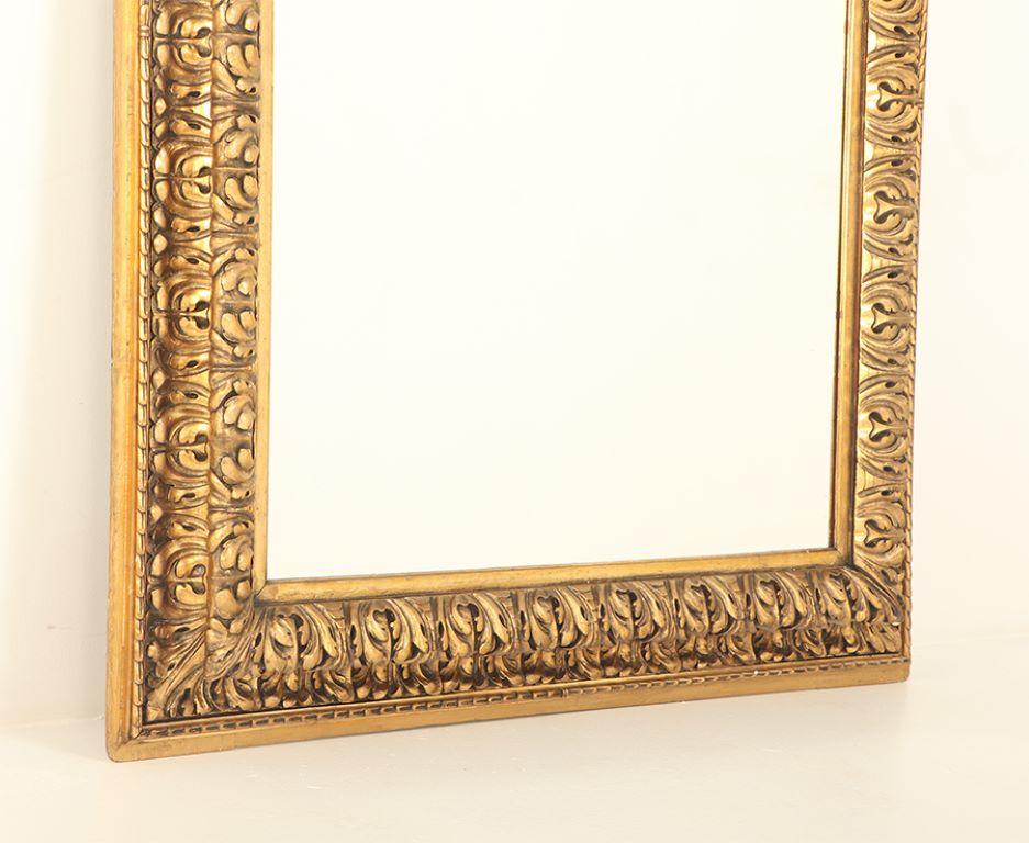 Wood A Nineteenth Century continental relief and gilt carved mirror. For Sale