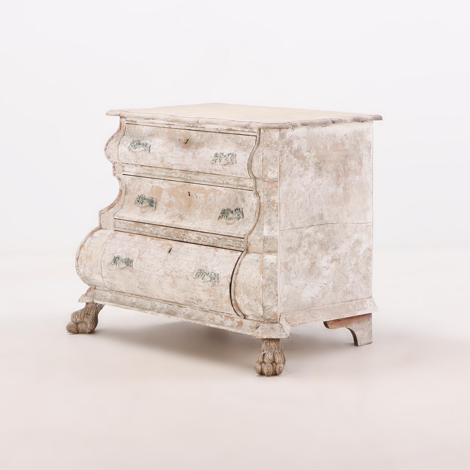 A Nineteenth Century Dutch bombay three drawer commode in bleached finish with claw feet. 