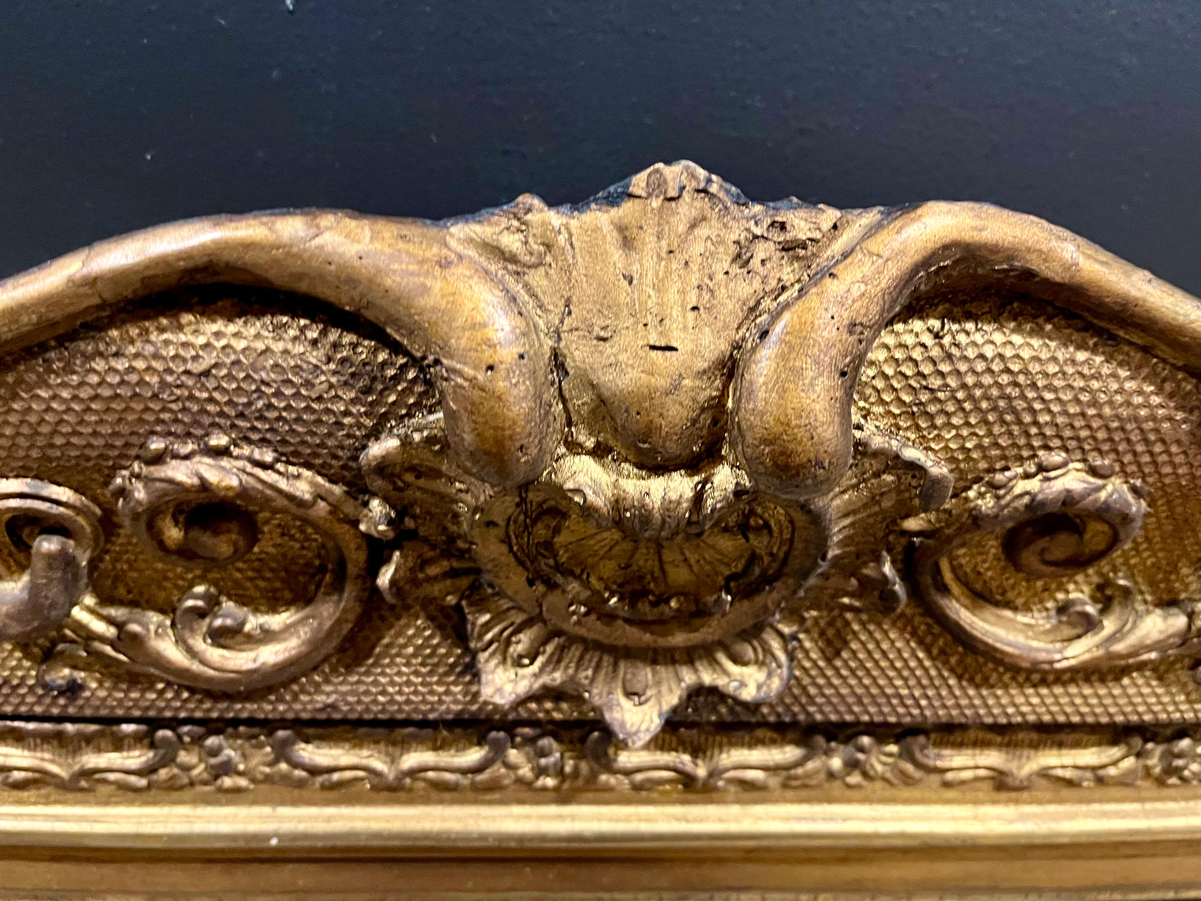A Nineteenth Century European gilt and gesso mirror carved in the Neoclassical style having festoons of C scrolls upon a diapered ground and beading. Attribution Jean Cherin.