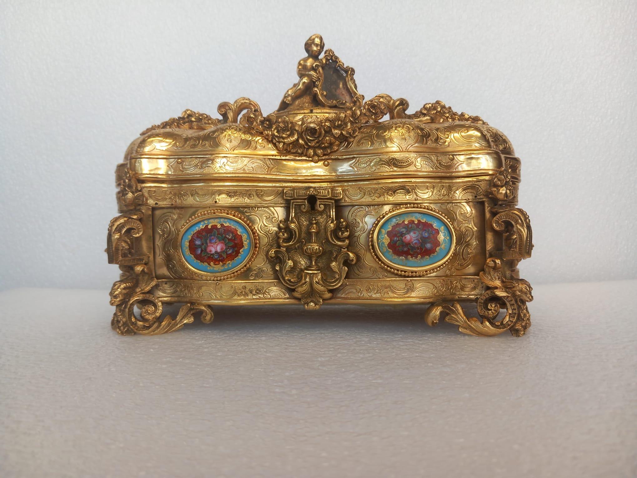 Rococo A nineteenth century French ormolu casket, in the medieval style, with a cherub For Sale