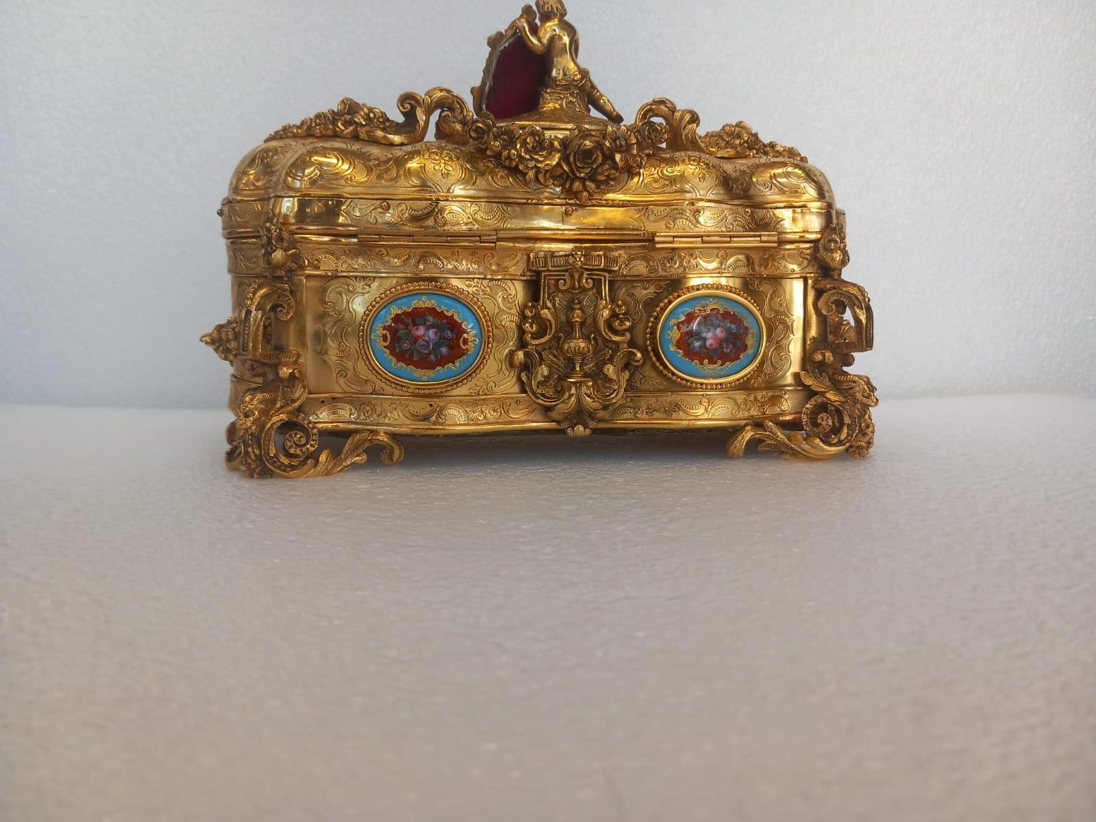 Gilt A nineteenth century French ormolu casket, in the medieval style, with a cherub For Sale