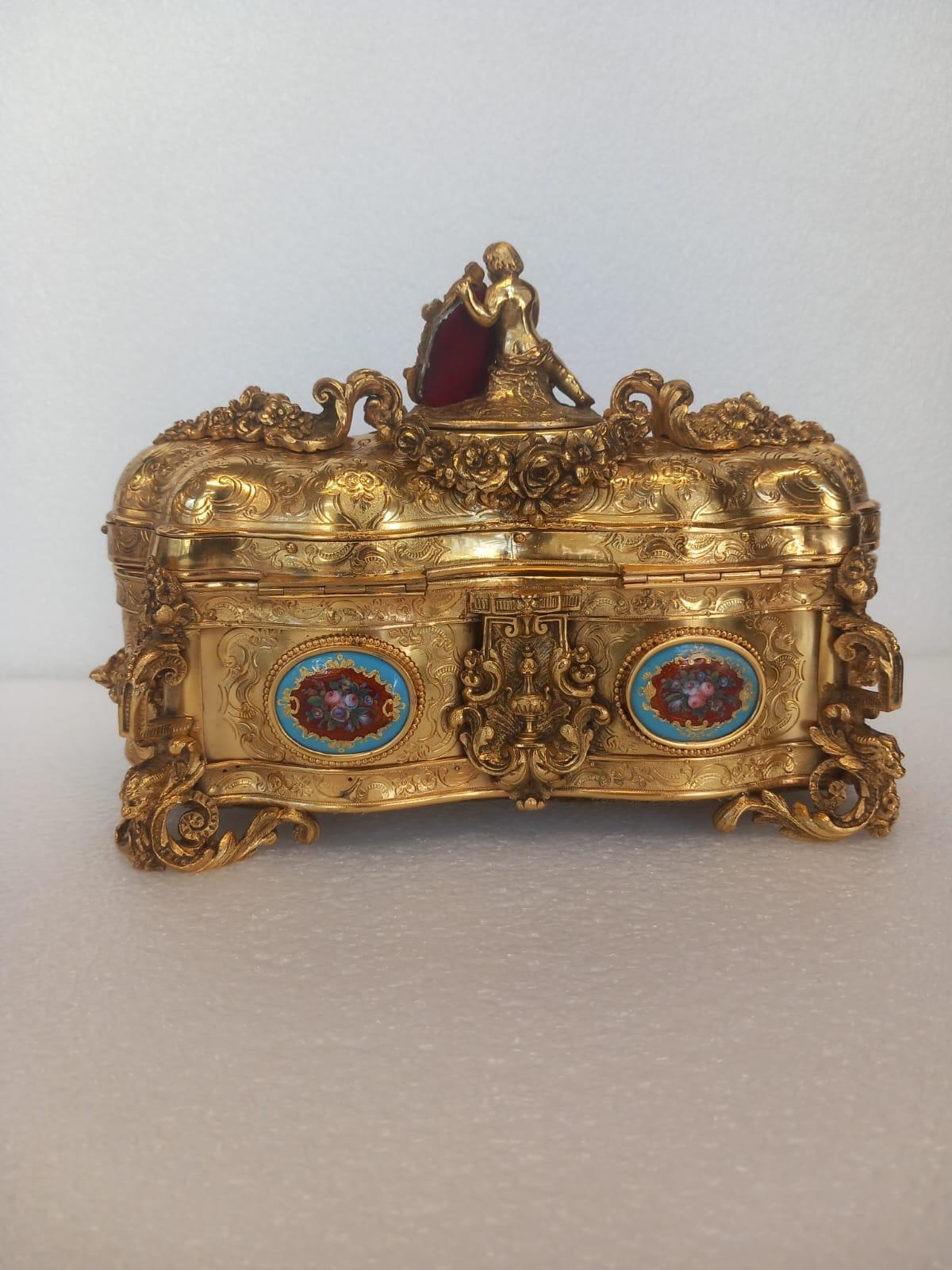 Bronze A nineteenth century French ormolu casket, in the medieval style, with a cherub For Sale