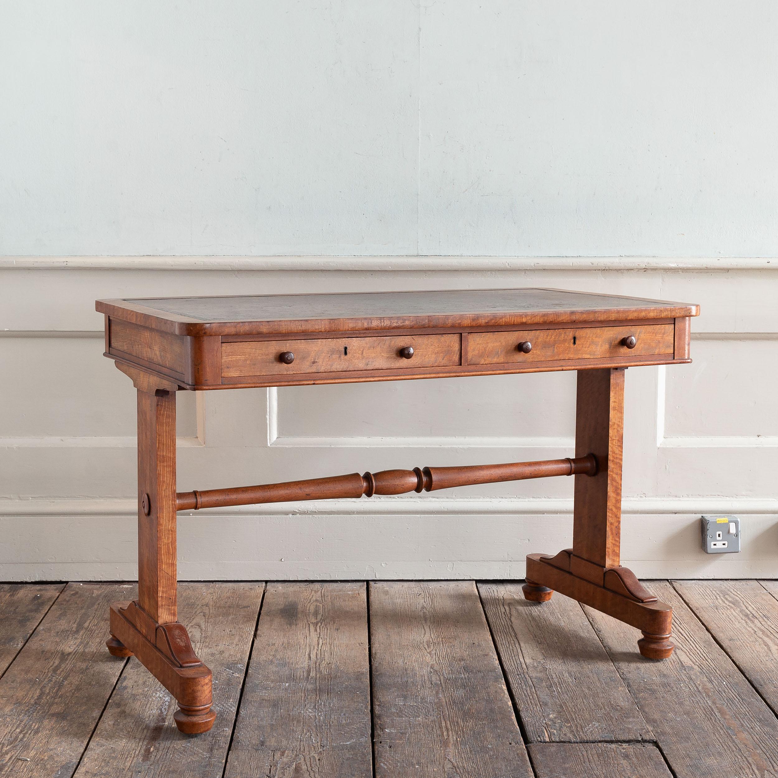 A nineteenth century satinwood writing table, circa 1825, the attractively worn leather skiver with traces of gilt to the tooled border.

Dimensions:	72.5cm (28½