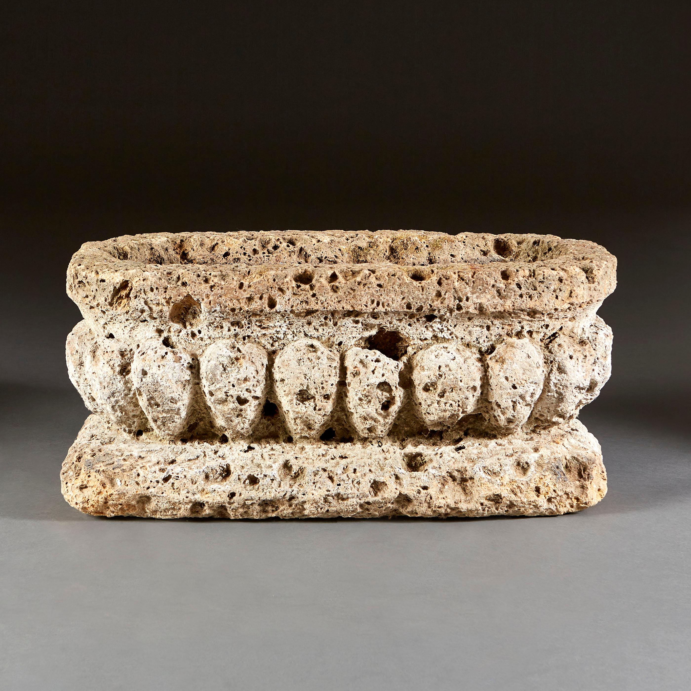 A late nineteenth century tufa rock jardinière of rectangular form with deeply gadrooned sides, supported on a rounded plinth base.