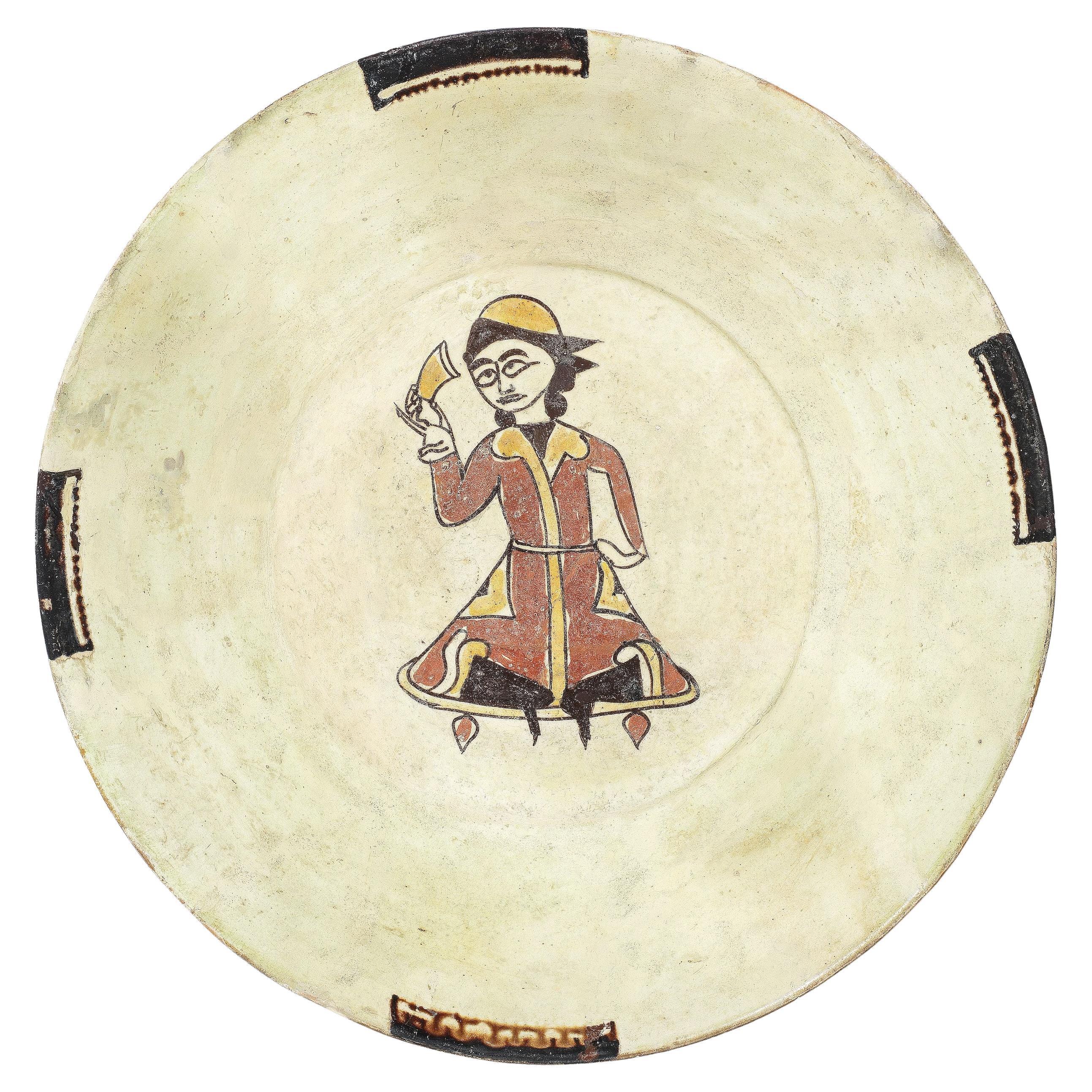 A Nishapur Slip-Painted Pottery Bowl Depicting A Seated Figure, 10TH Century