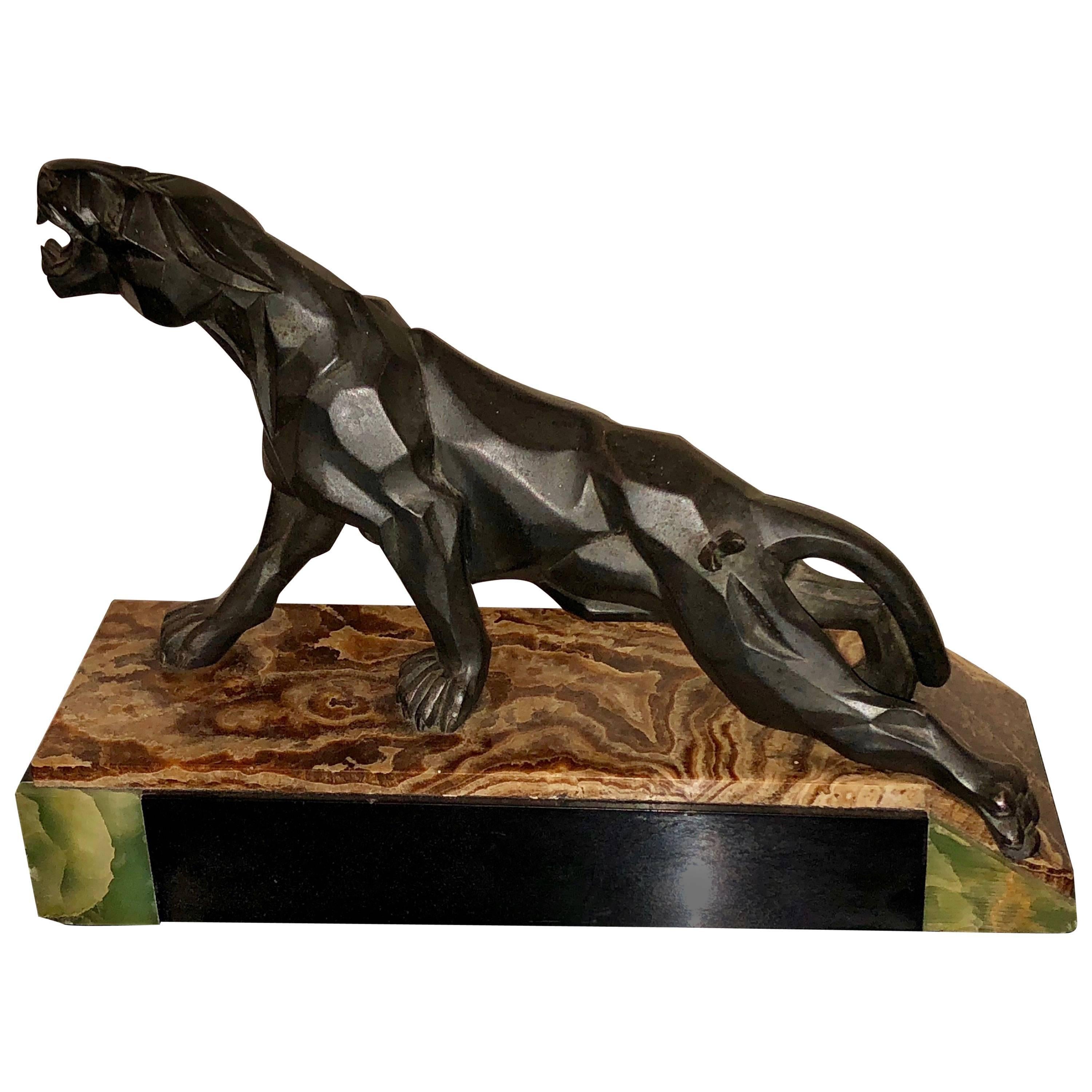1930s Cubist sculpture of a climbing and growling panther on the prowl. Art Deco design with the artistic facet-like details are imaginative and convey a sense a strength, power and ferocity. This bold sculpture is in excellent original condition.
