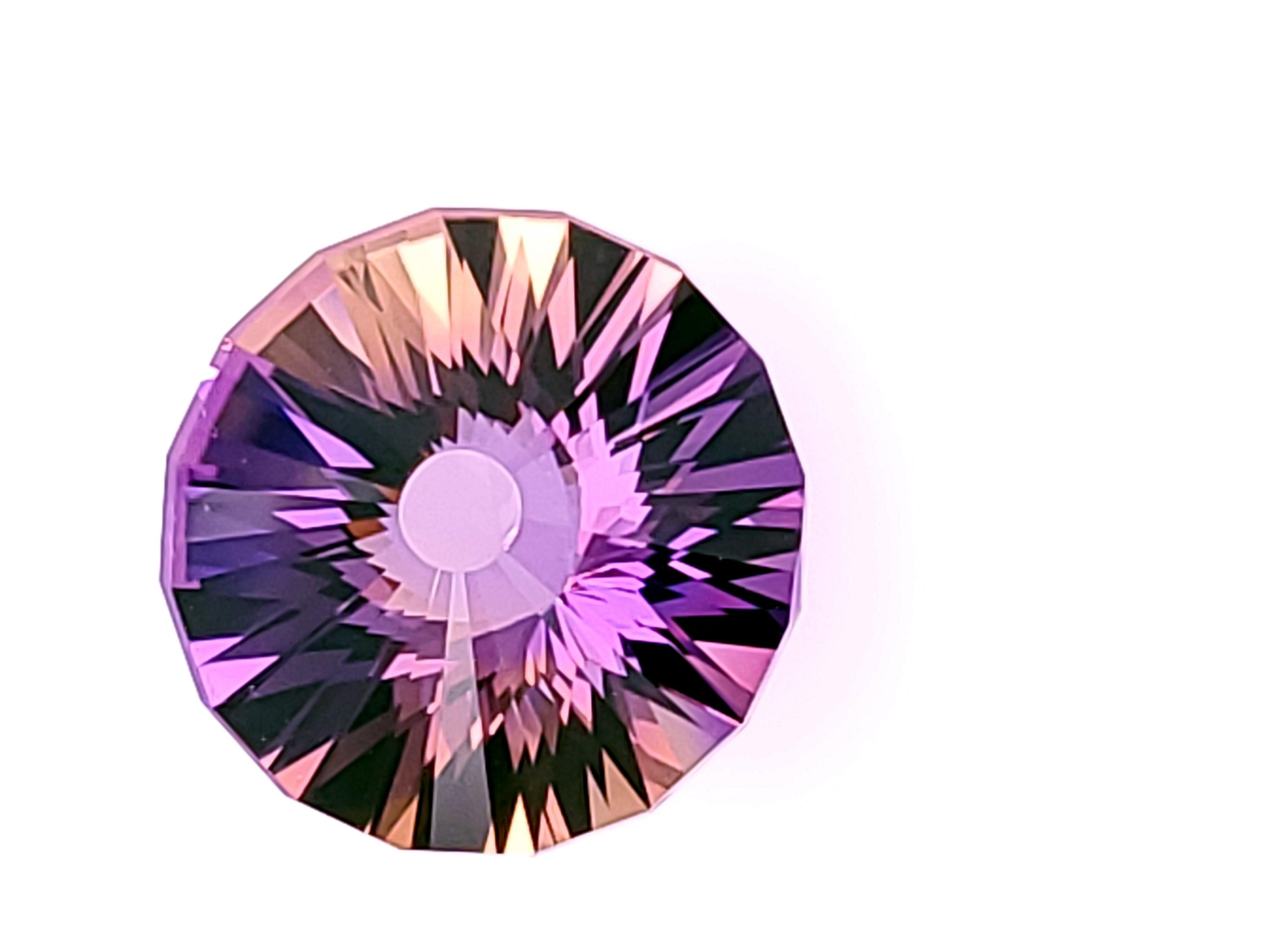 A Lively Blended Natural Ametrine in a Fancy Round Design weighing 13.18cts.  This particular gemstone was faceted from our rough by one of our Specialty Cutters, creating this unique, brilliant, lively multi-colored beauty!   Our rough is hand