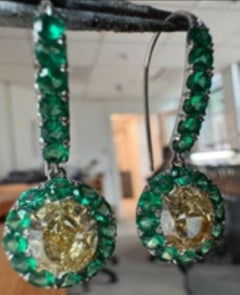 A Oval 3.21 WX VVS1 and 3.17 YZ VVS2 Diamond and Emerald Earrings