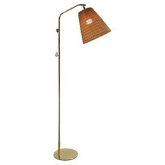 A Paavo Tynell Floor Lamp Model 9613 with Rattan Shade