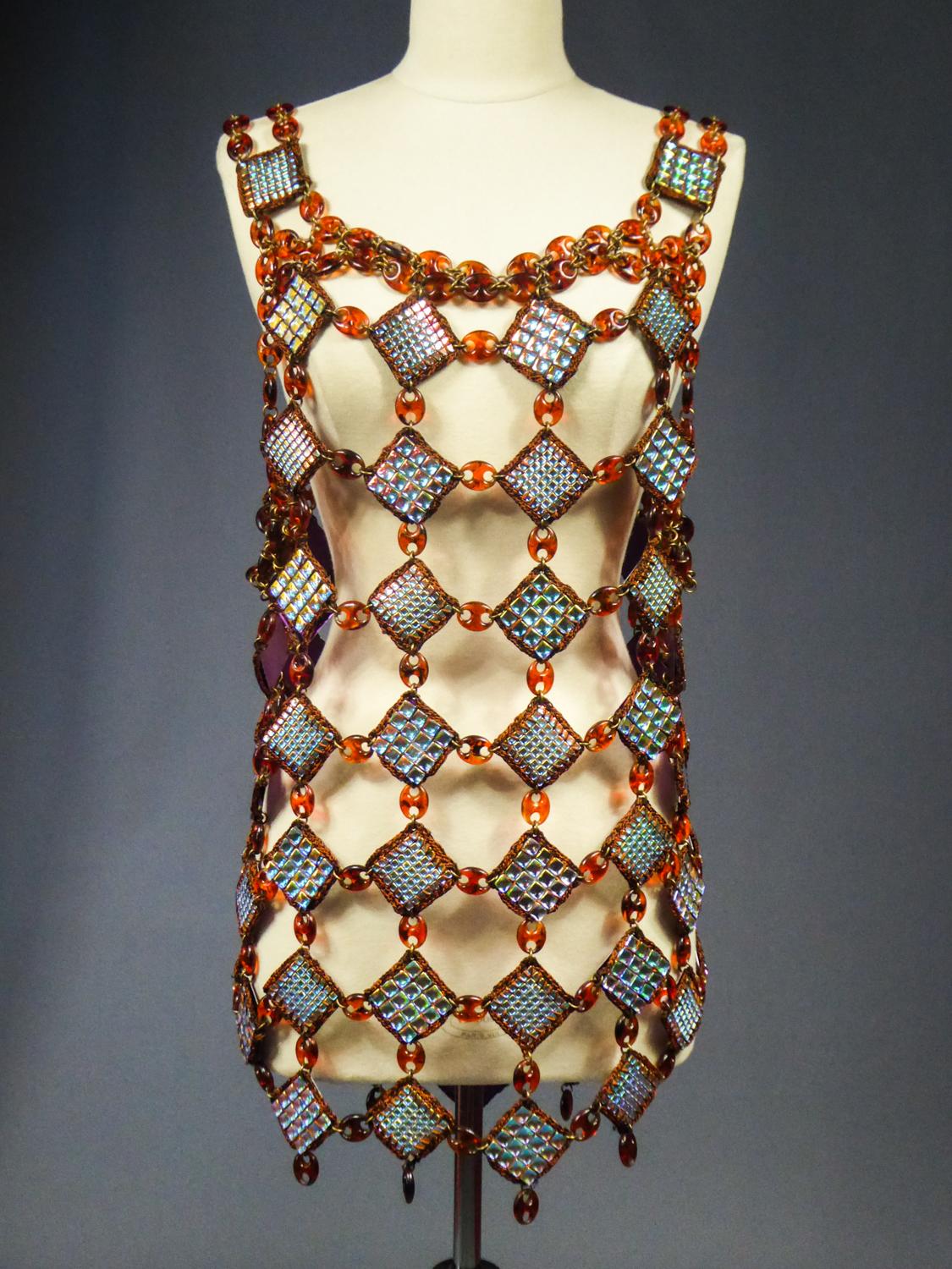 Circa 1980
France

Astonishing Haute Couture Paco Rabanne jewel dress or tunic without label and dating from the 1980s. Superb work of diamonds with iridescent silver pastilles framed by embroideries of brown silk threads. Assembly in links of brass