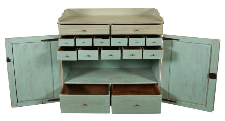 We love this unique piece for its beautiful color and its simple, yet elegant design. Perfect in a hallway, kitchen or dining room, this server is painted in a lovely bluish gray. The server features two storage drawers over two drawers adorned with