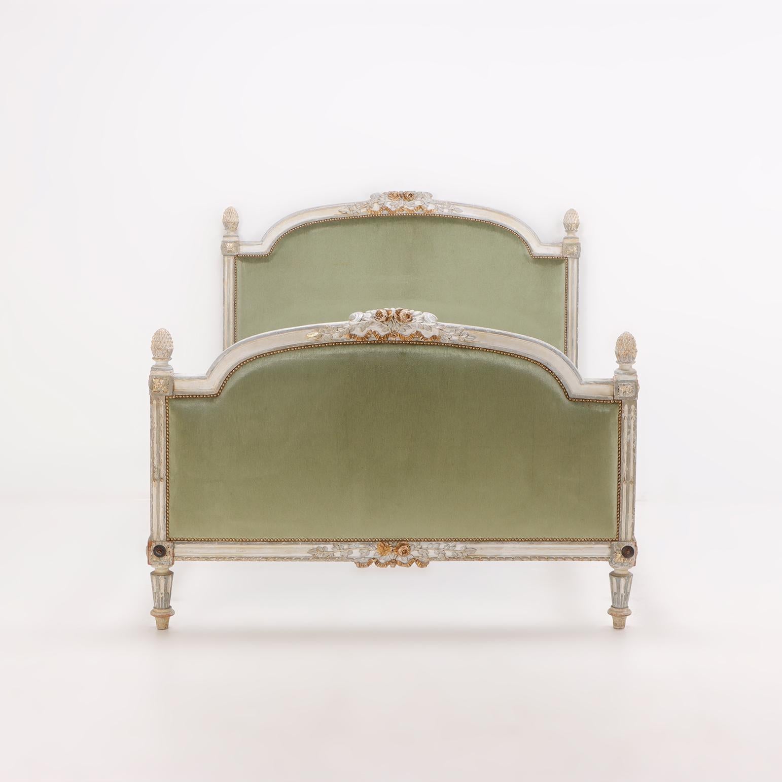 A painted and carved French Louis XV full size bed having an upholstered head and footboard, circa 1800.
Interior Dimensions: 54