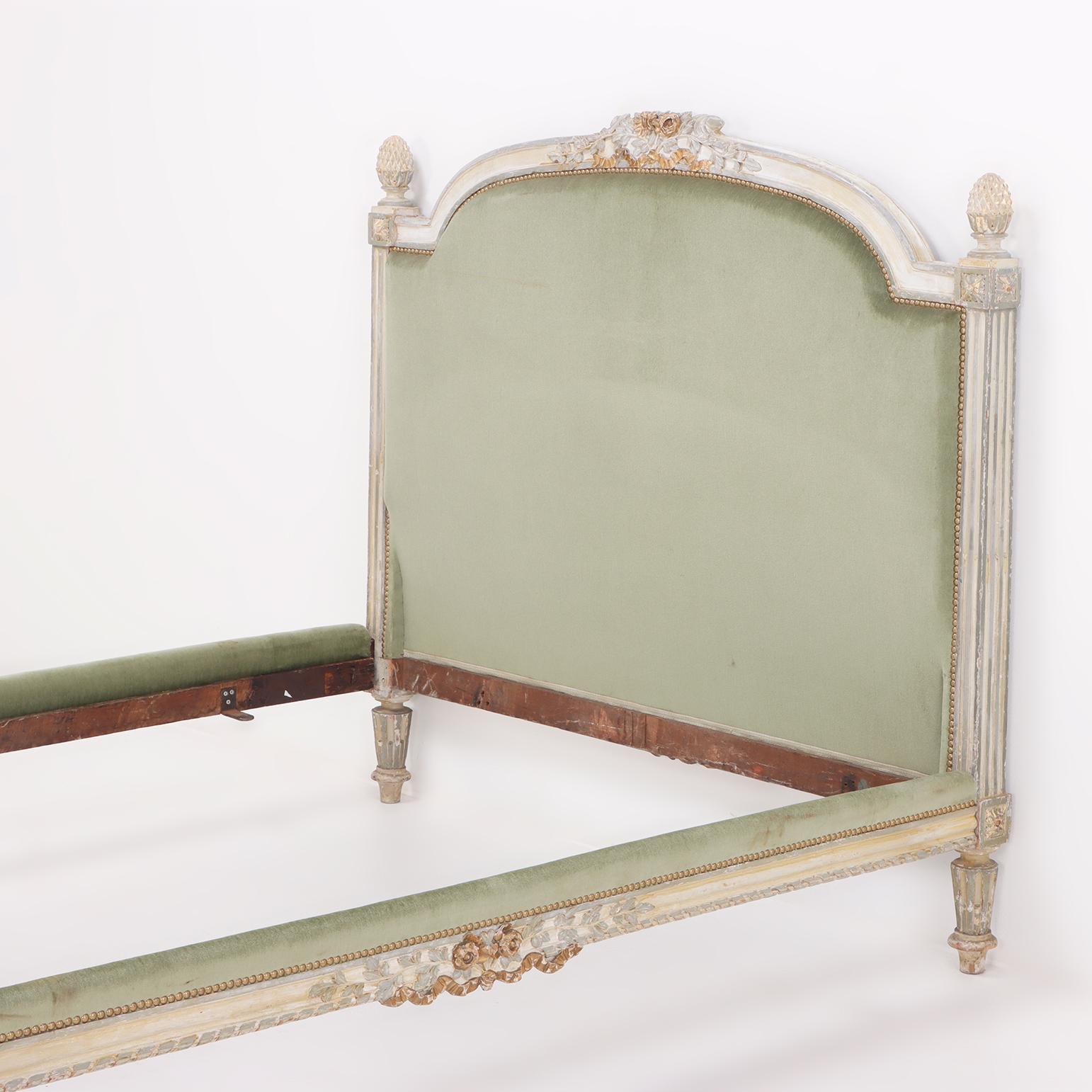 Painted A painted and carved French Louis XV full size bed circa 1800.