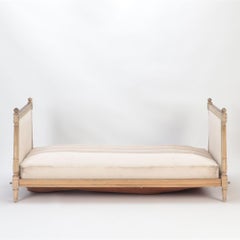 A Painted French Directoire style daybed with cushions C 1910.