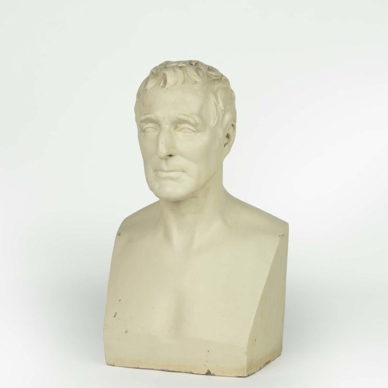 This plaster bust of Arthur Wellesley, 1st Duke of Wellington is a replica of the original marble portrait bust, commissioned, in 1852, by the Duke’s heir for Stratfield Saye, Hampshire, the family seat.  It is based on his death mask, which was