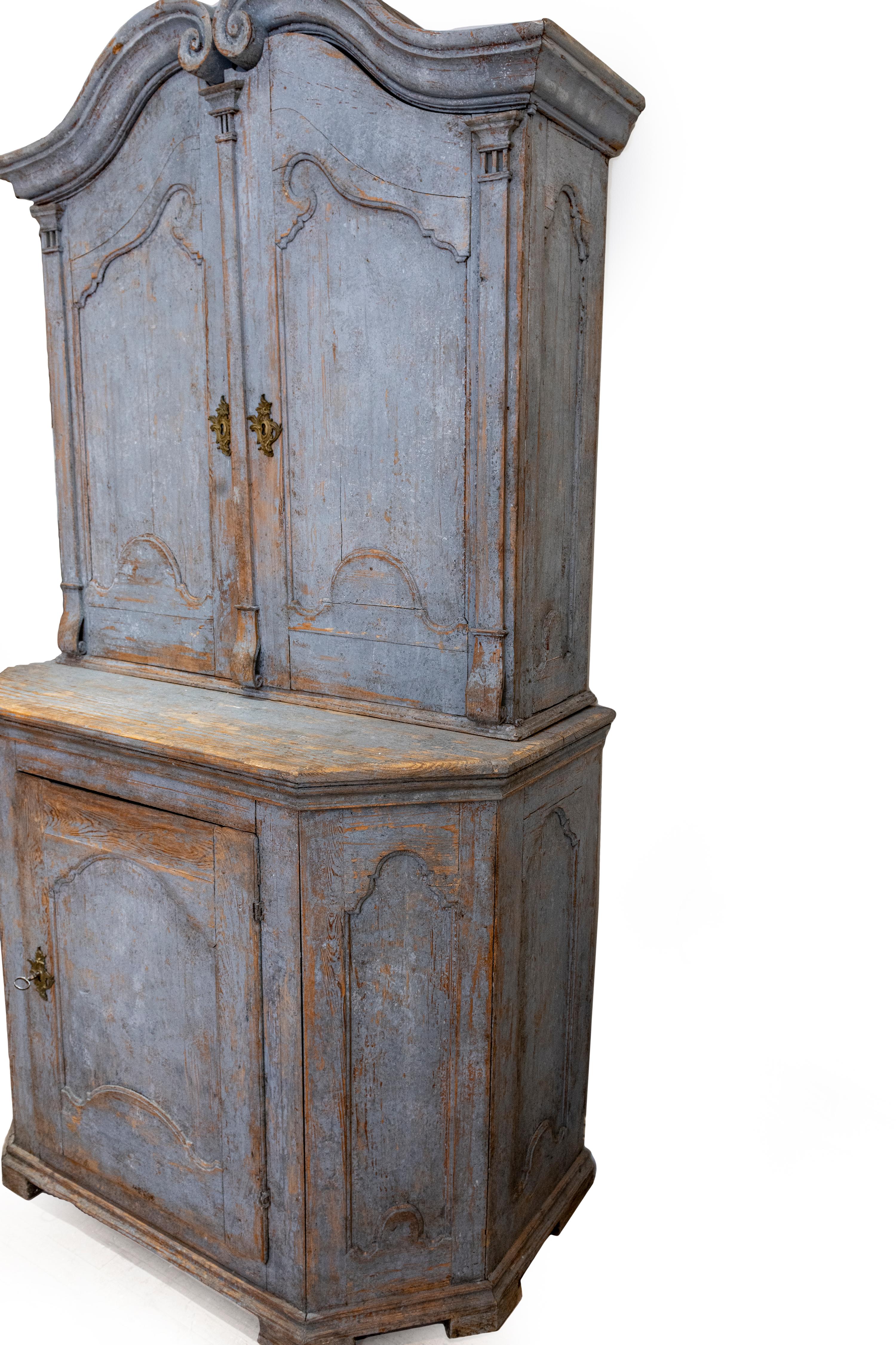 Original blue paint, carved wood display cabinet with unique original display shelving. Very sturdy cabinet in two pieces. Original shelving in the bottom cabinet as well.
 