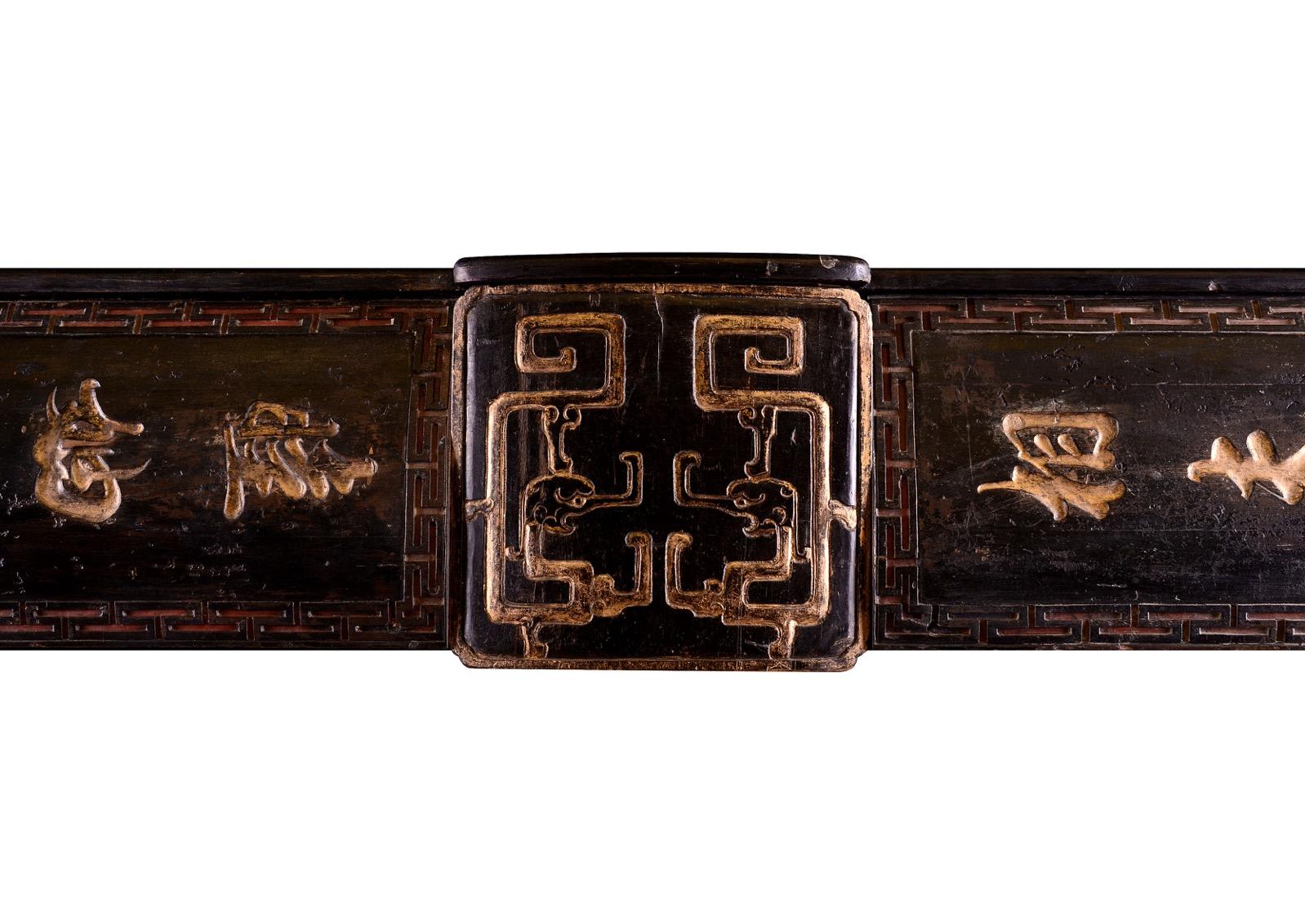 An architectural timber fireplace with Eastern influence. The jambs and frieze with Chinese symbols throughout, the plinths and centre block with matching motifs. English, 19th century.

Shelf Width:	        1575 mm /   62  in
Overall Height:	1265