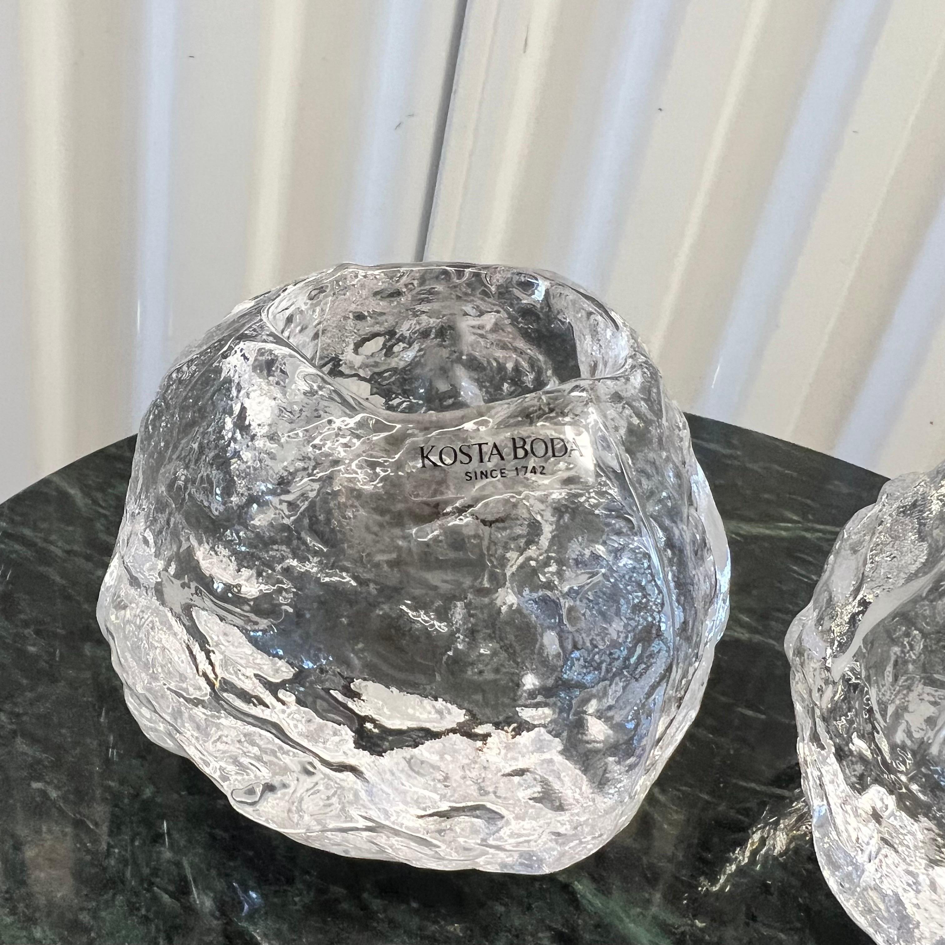 This is a set of vintage 1970's Kosta Boda Snowball Candle Holders by Ann Warff. Crafted out of heavyweight, lead-free, clear crystal. Original stickers are on both.  And both are signed on the bottom. Each measures approximately 3