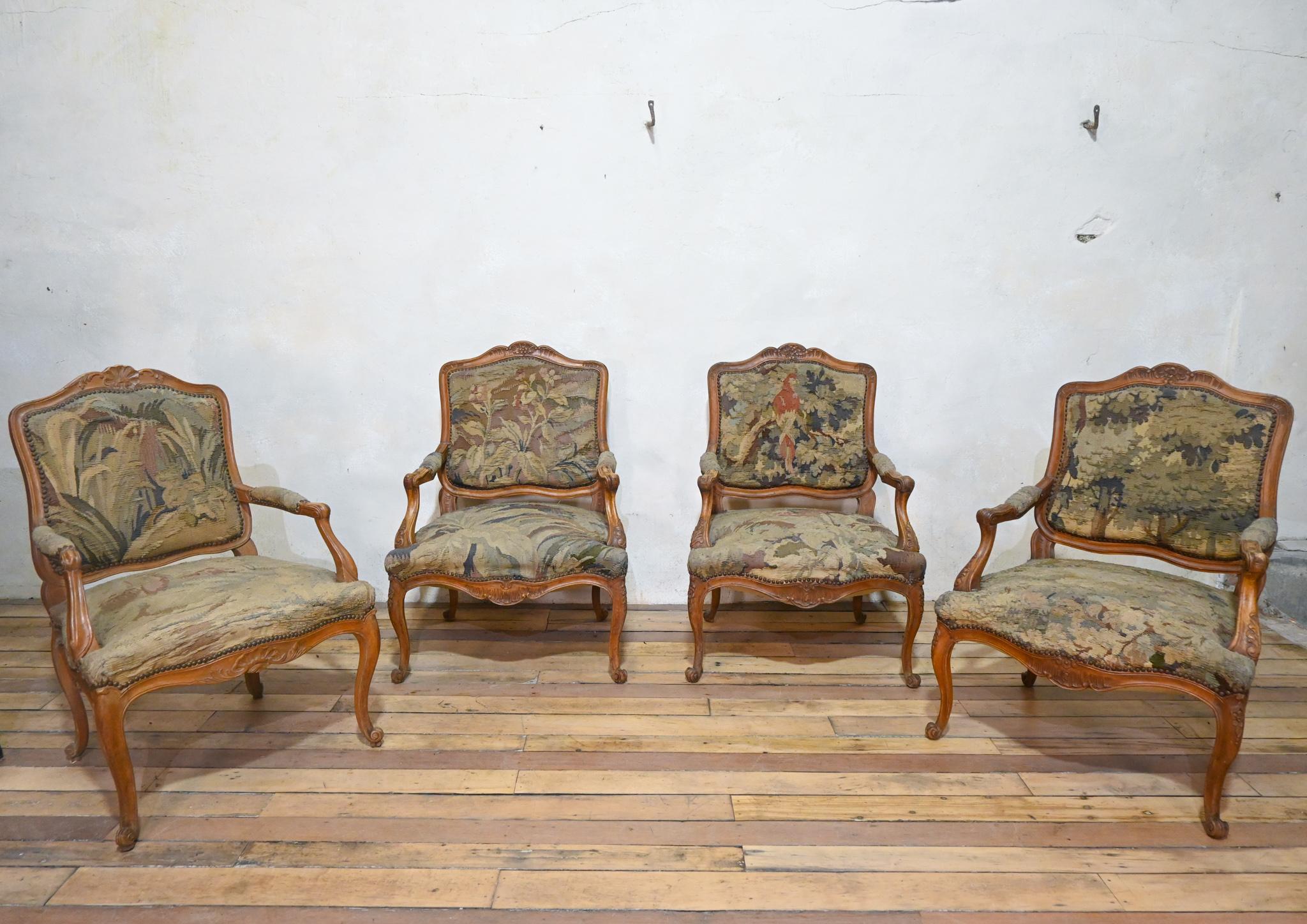 A near pair of 19th century French Louis XV style Fauteuils open armchairs, upholstered Aubusson Tapestry.  
Displaying cartouche shaped backs, demonstrating foliate scroll cresting with foliate scroll arm supports and serpentine padded seats.  