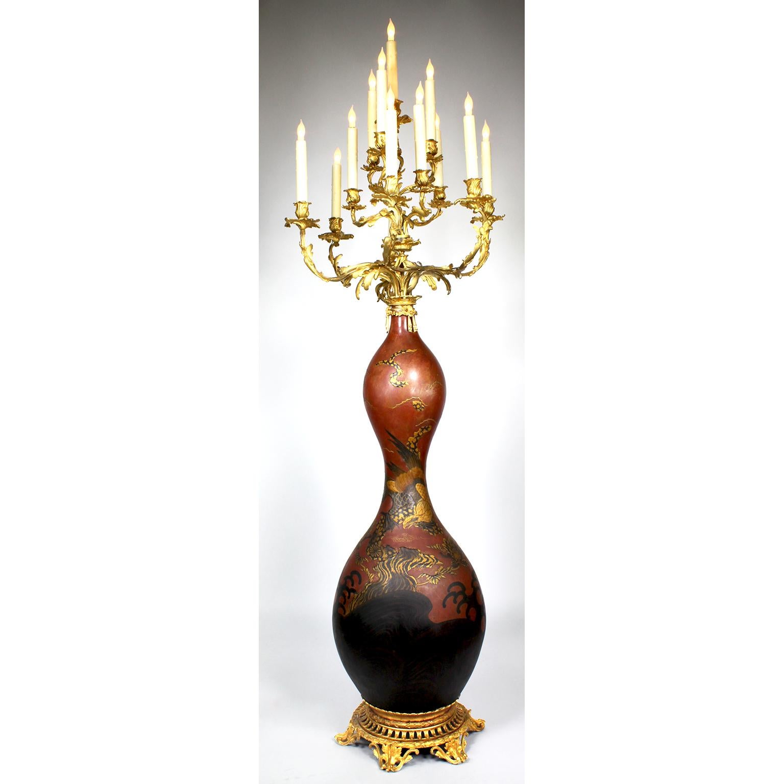 A fine Pair of 19th century Japanese Imari Porcelain and French Gilt-Bronze Mounted Thirteen-Light Celadon Torchere Candelabra. The bottle-shaped Japonisme vases with a Royal red background, decorated with parcel-gilt and black soaring eagles in the