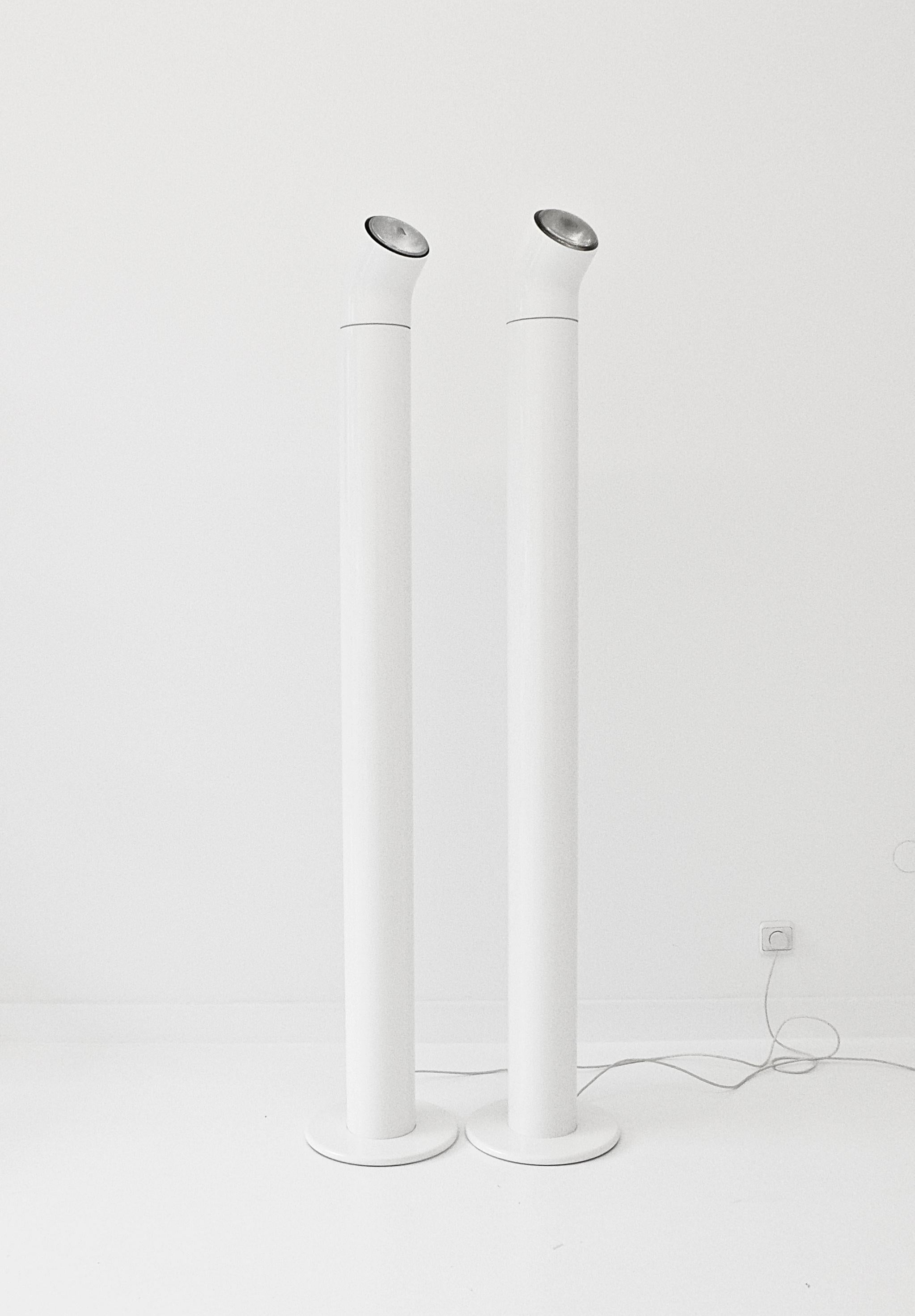 a pair of alain richard a19 floor lamps for disderot, france 1967. the base and the rotating angled part of the lamp are in white lacquered cast aluminium, the middle part is a pvc tube with black light switch at about shoulder height. very good