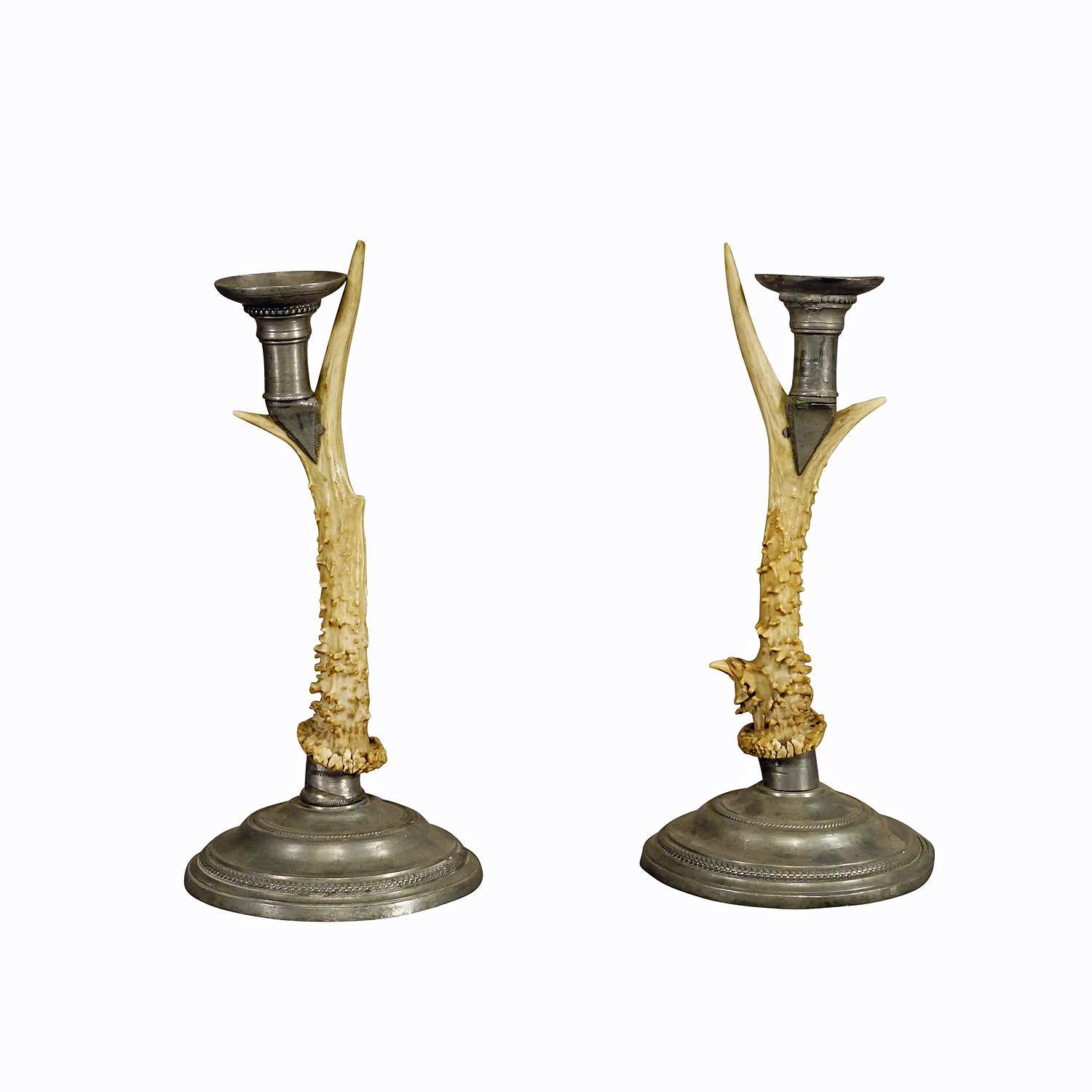 Pair Black Forest Candle Holders with Pewter Base and Spout, Germany circa 1860s

An antique pair of Black Forest candle holders with pewter base and spouts. Each made with an original deer antler. Manufactured in South Germany mid 19th century.