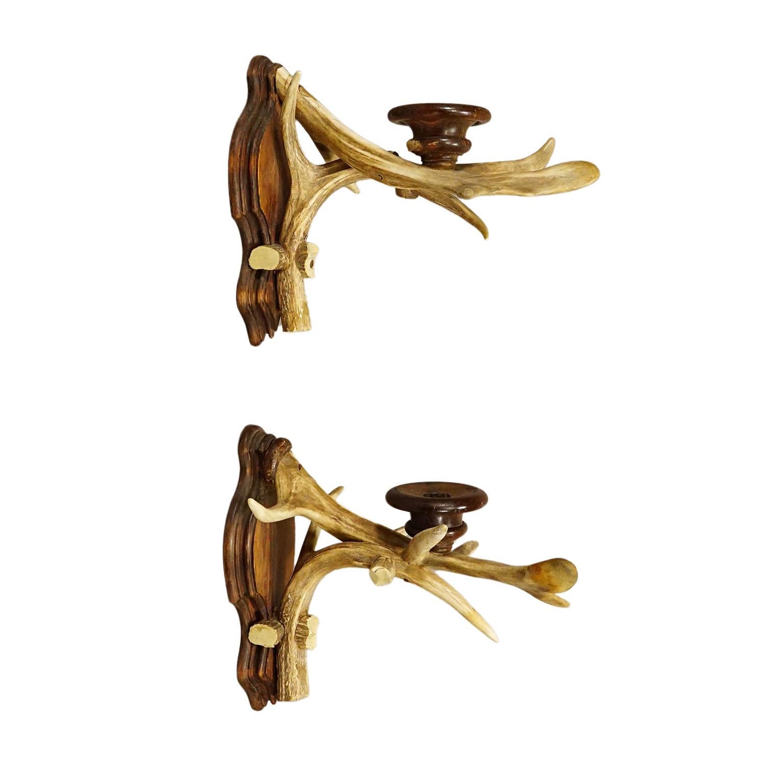 A Pair Black Forest Candle Sconces with Deer Horns, Germany ca. 1920
Item e6862
An antique pair of Black Forest sconces for candles. Each made of original deer horns which are mounted on a carved wooden base. Spouts made of turned wood. Executed in