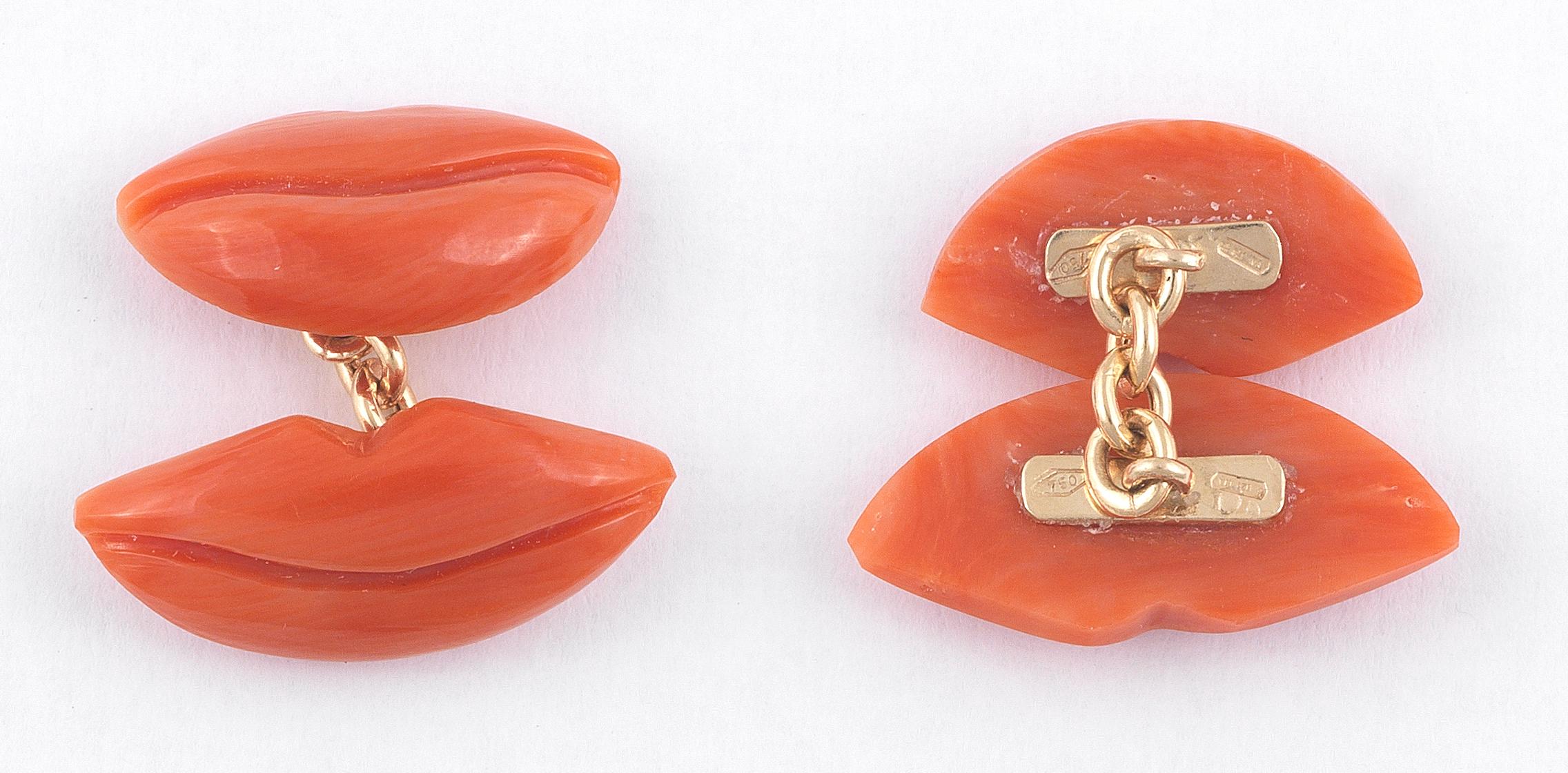 
A pair of carved corallium rubrum lip motif cufflinks in 18ct yellow gold chain link connections.