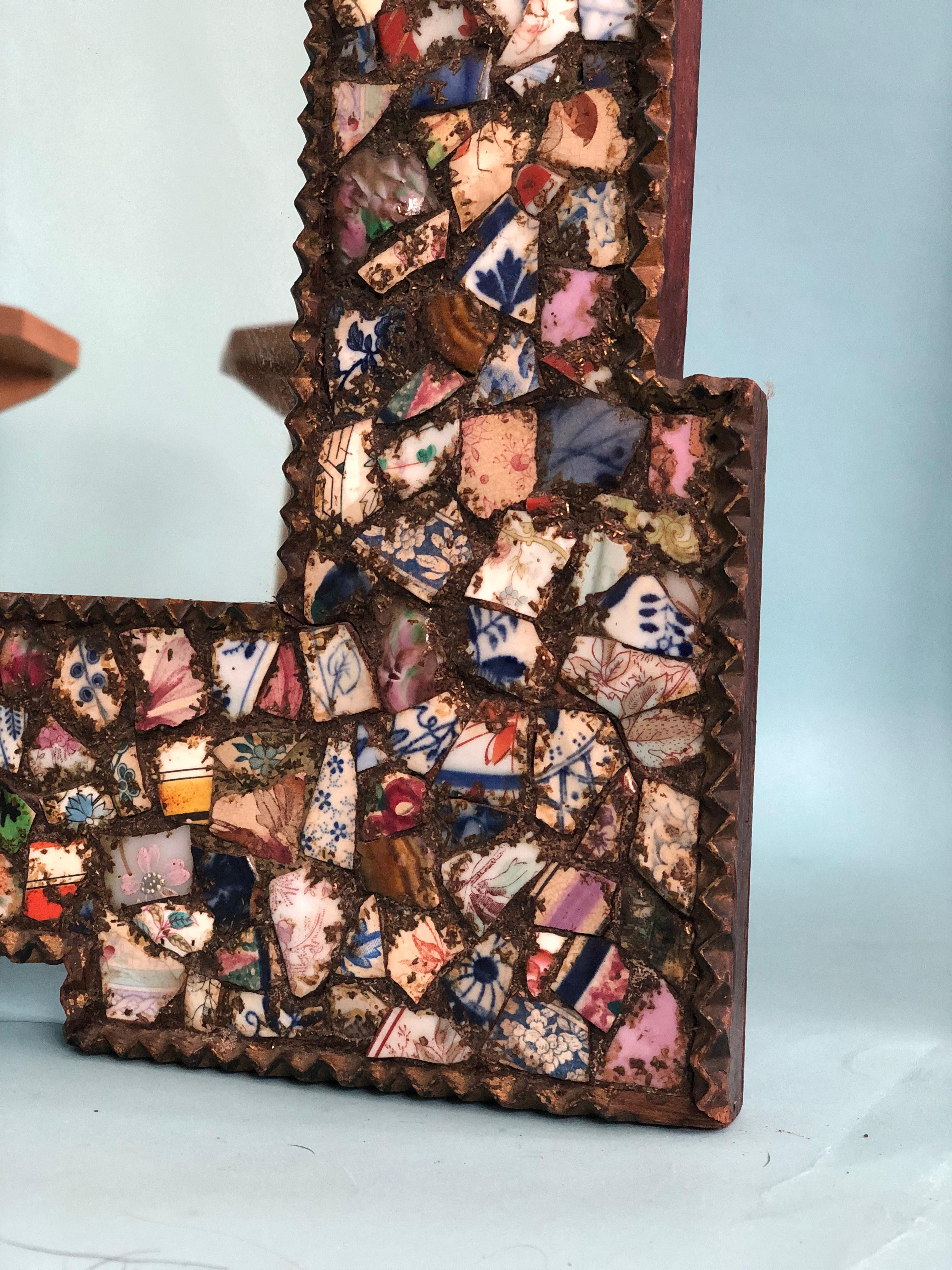 A pair handcrafted mirrors decorated with broken crockery. The colorful mosaic mirrors are decorated with all kinds of crockery and filled with gilt. The wooden edge of the frame has been carved.

Beautifully handmade and richly decorated mirror In
