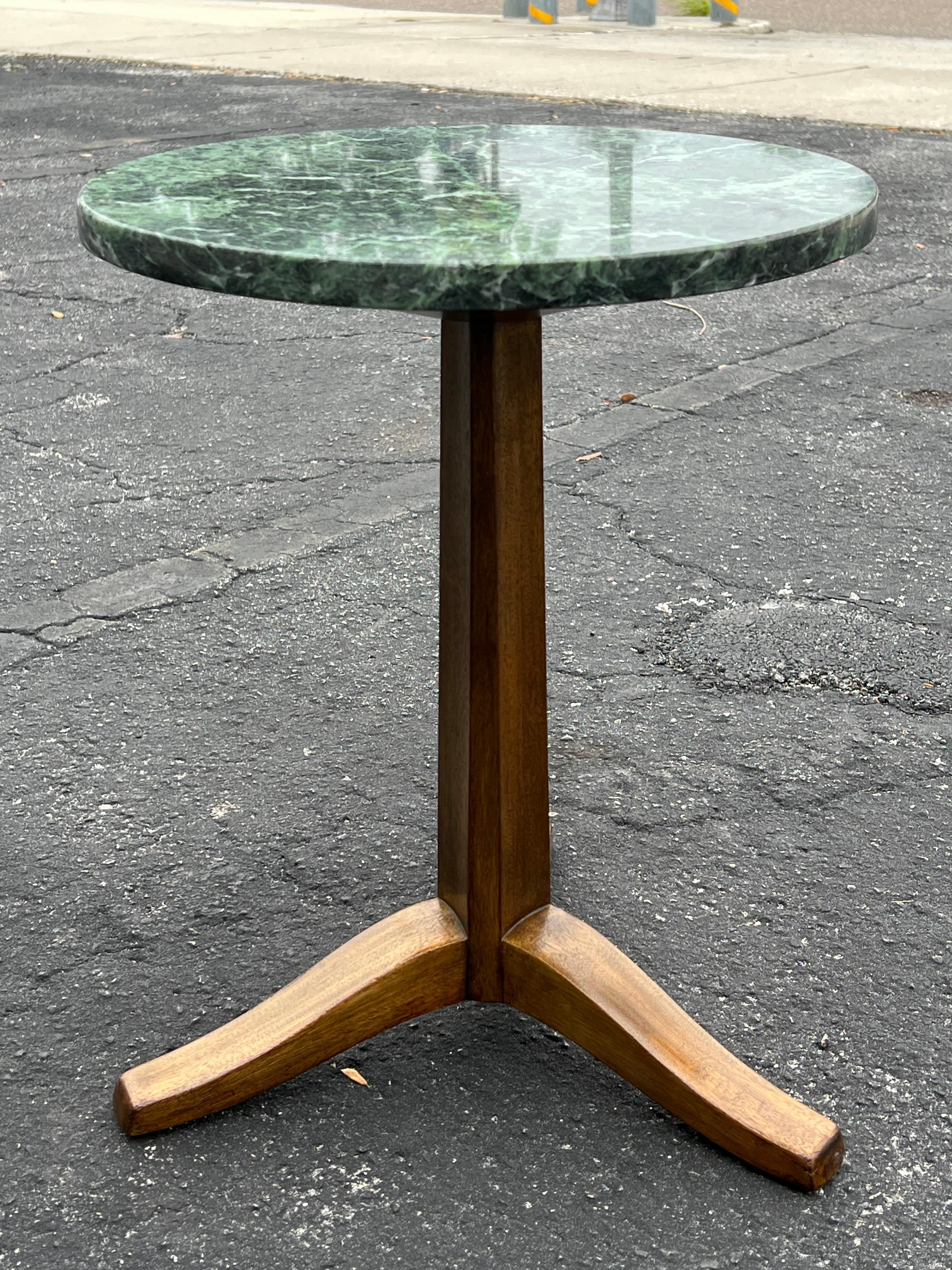 A pair of classic Edward Wormley for Dunbar gueridons or tripod base tables. Green marble tops.
