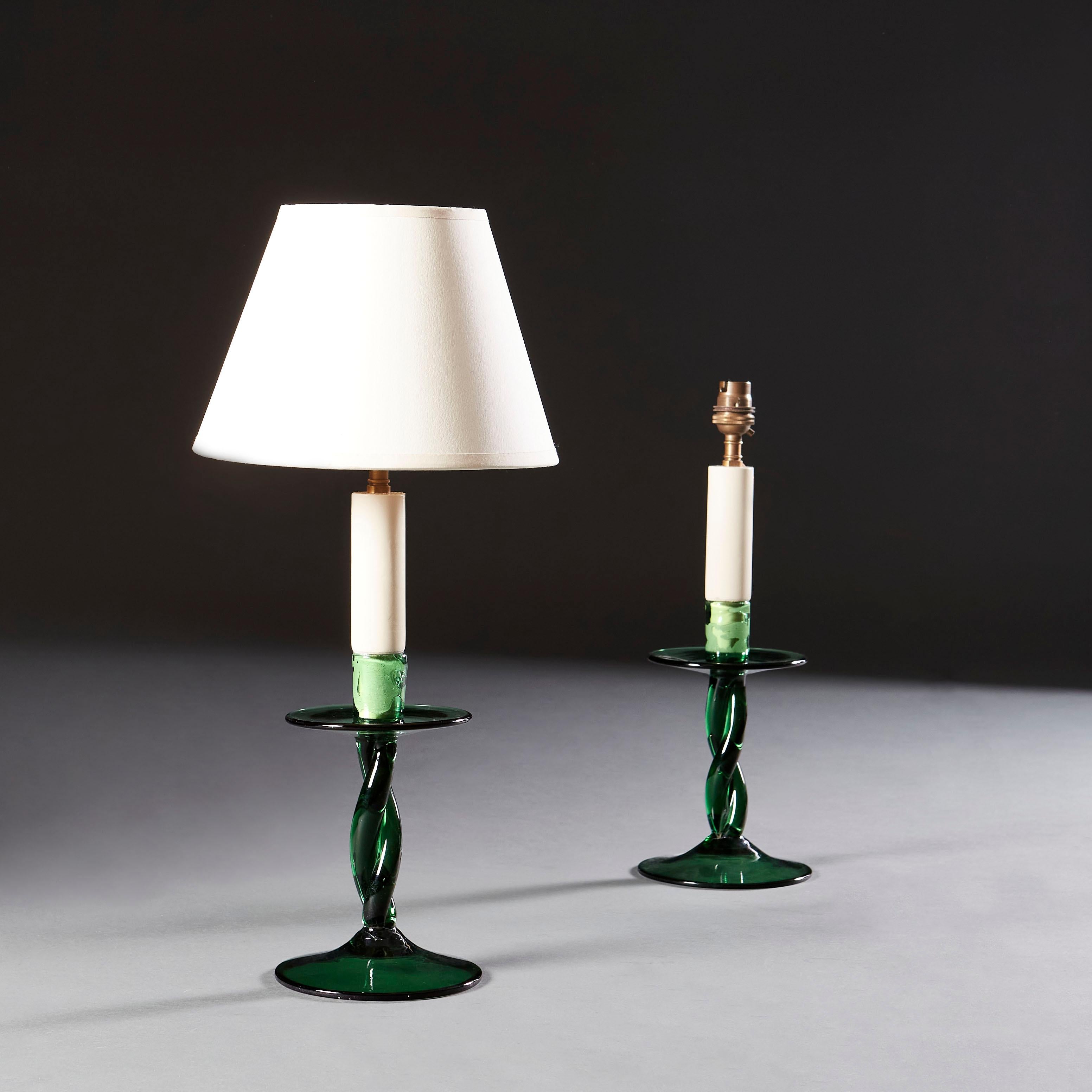 An unusual pair of green glass candlesticks with twisted stems, circular drip trays and bases now converted as lamps.

Currently wired for the UK. Please enquire for rewiring services.

Please note: Lampshades not included.