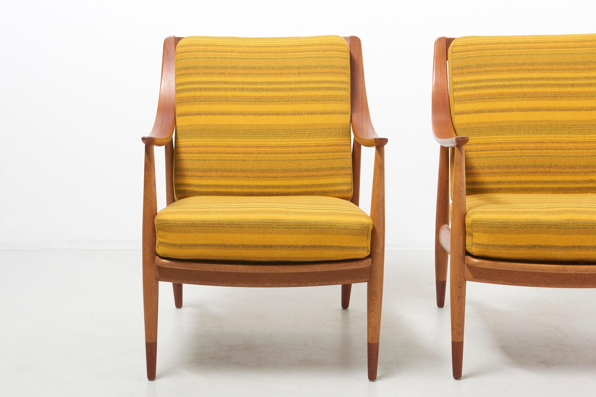 A pair of easy chairs designed in 1953 by Peter Hvidt and Orla Mølgaard-Nielsen. Model FD 144, made by France & Daverkosen. The frames are made of oak with parts in teak. Original cushions, with the original fabric. Excellent condition.