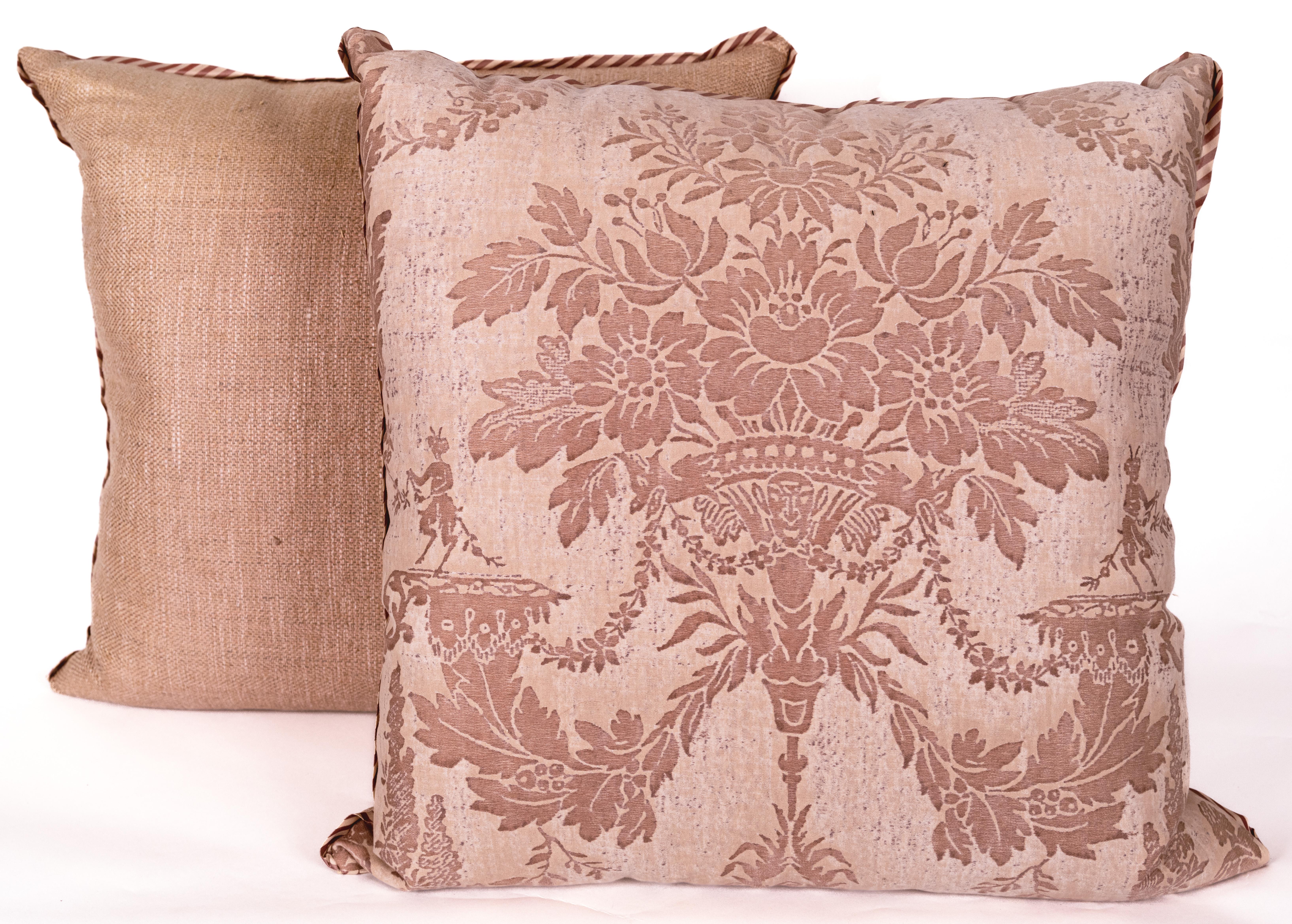 A pair of cushions in the now discontinued Fortuny 'Boucher' fabric. A classic damask style featuring flowers and Satyrs, rendered in a mottled Mauve.