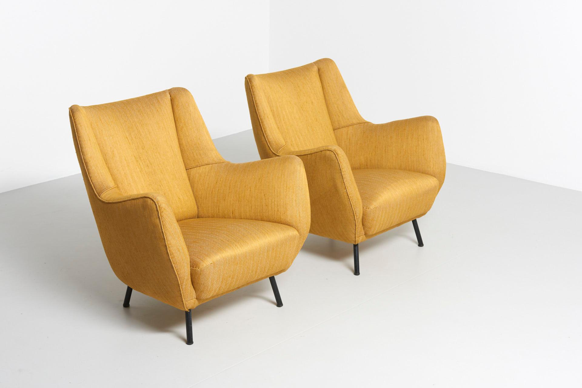 A pair Italian easy chairs in yellow herringbone fabric with black metal legs. In the style of Guglielmo Veronesi. Made in Italy in the 1950s.