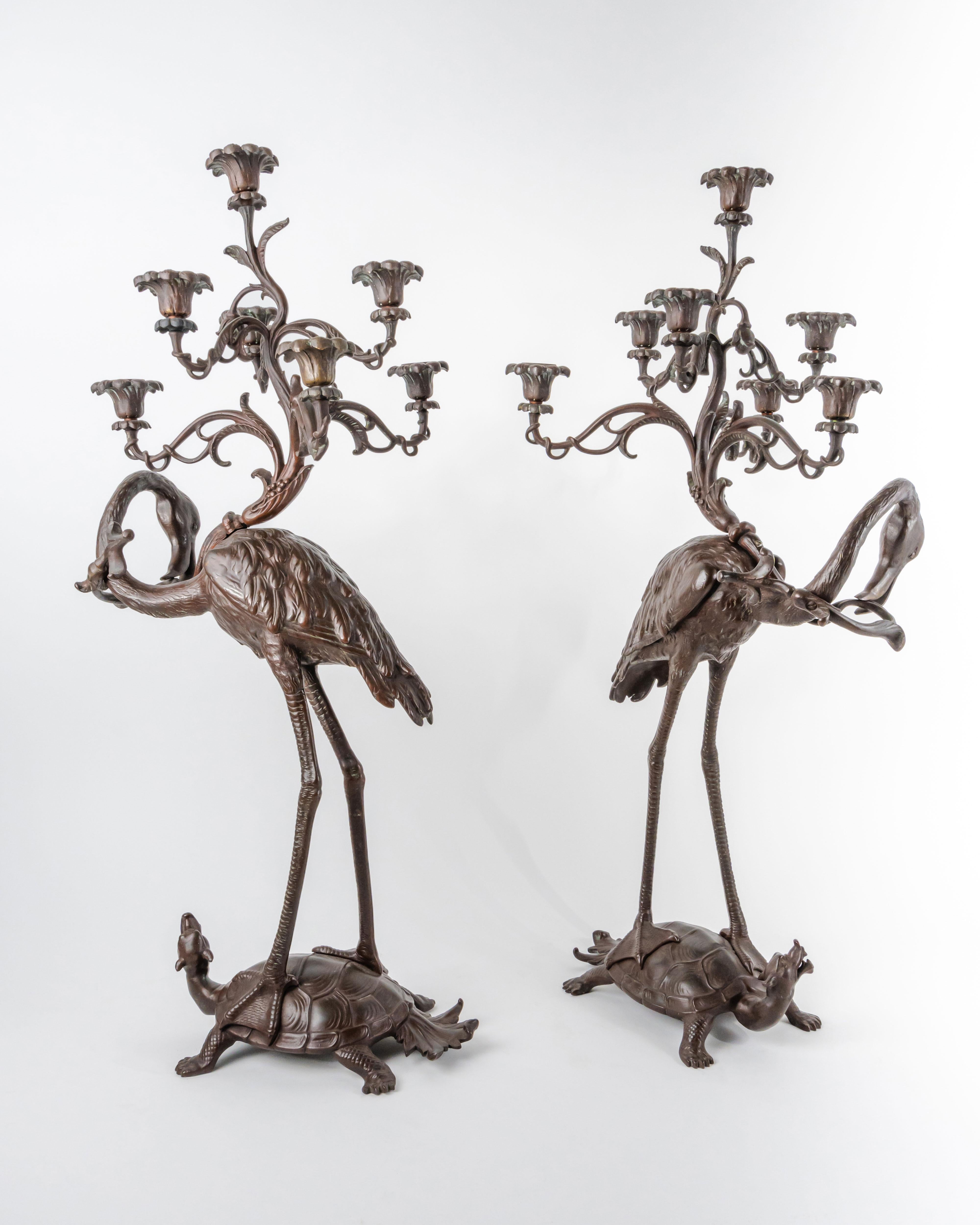 A Pair of French Japonaise patinated bronze seven light candelabras. Circa 1880.
Based on a Japanese model, each as a flamingo holding a budding twig and standing on the back of a mythical tortoise. 

Measures: 28-1/2