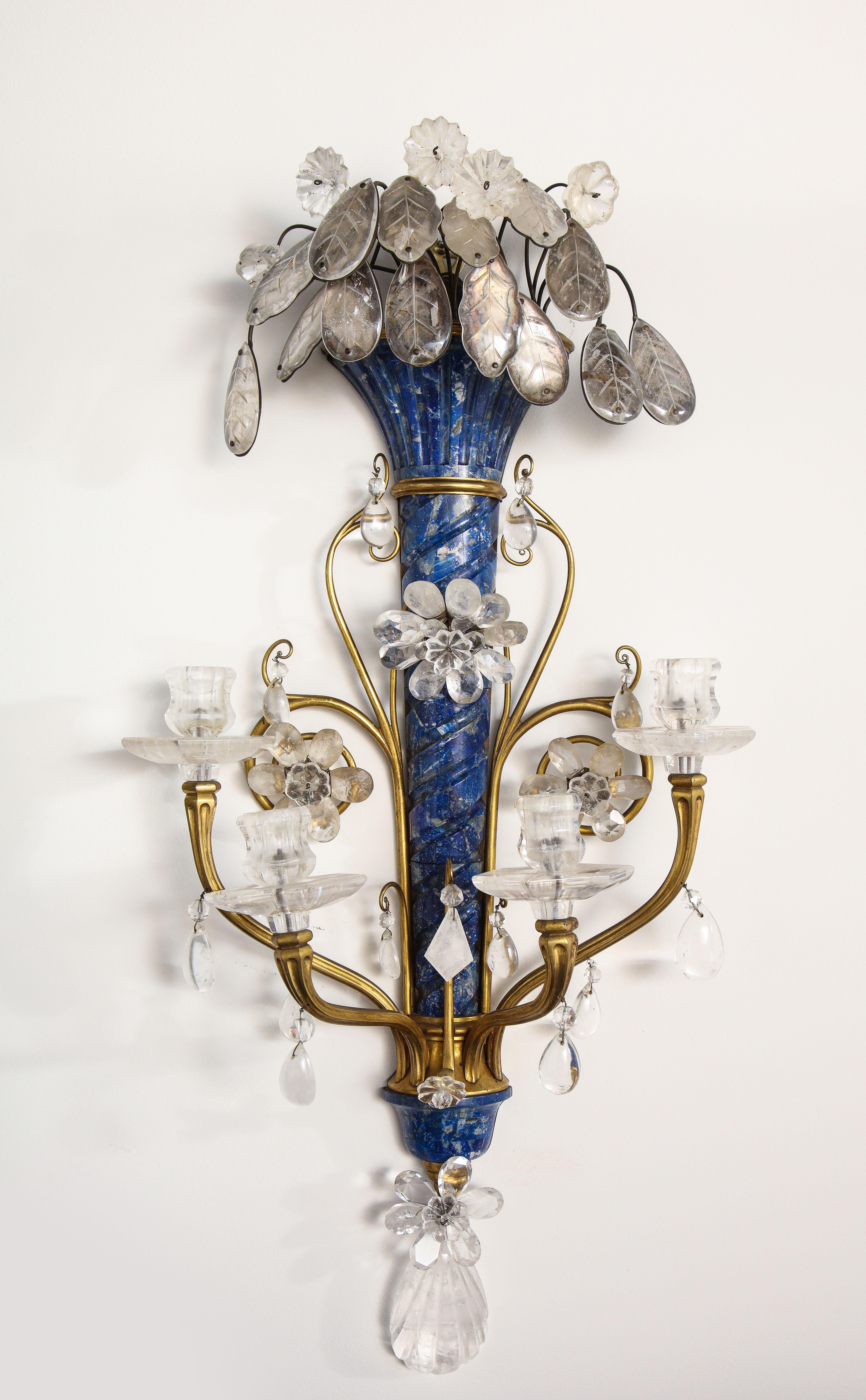 A very fine and unusual pair of Louis XVI Style E.F. Caldwell hand carved Lapis Lazuli, rock crystal, doré bronze and gilt metal four arm wall appliques/sconces. These are truly an exceptional pair of sconces with the highest quality of Caldwell