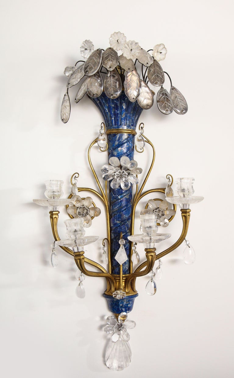 A very fine and unusual pair of Louis XVI Style E.F. Caldwell hand carved Lapis Lazuli, rock crystal, doré bronze and gilt metal four arm wall appliques/sconces. These are truly an exceptional pair of sconces with the highest quality of Caldwell