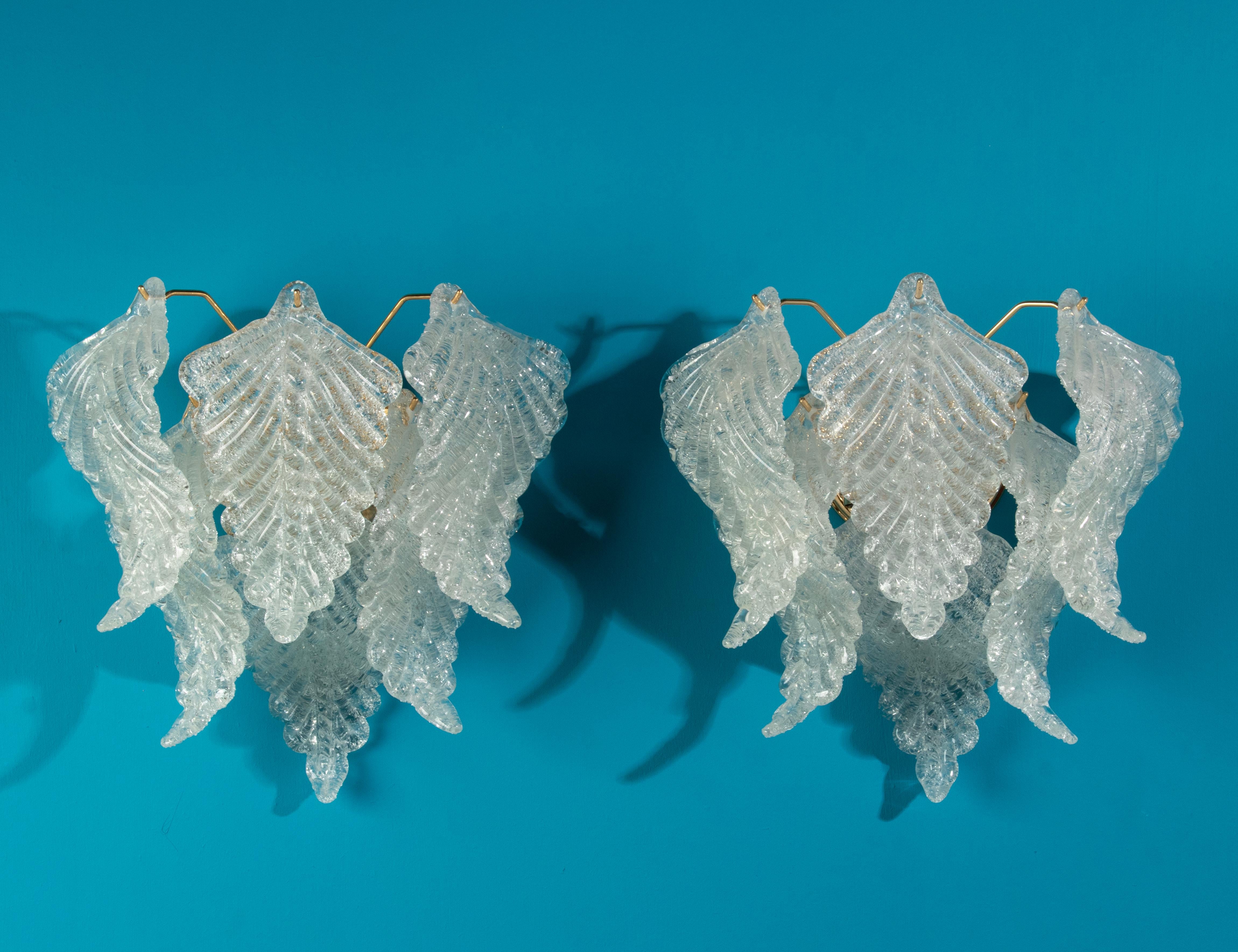 A beautiful pair Italian wall Sconces, made by Industria Veneziana Lampadari. 
Frosted Murano glass leaf shaded glasses

Estimated date: circa 1970. 
Dimensions: 35 (h) x 36 x 21 cm.
Free shipping worldwide