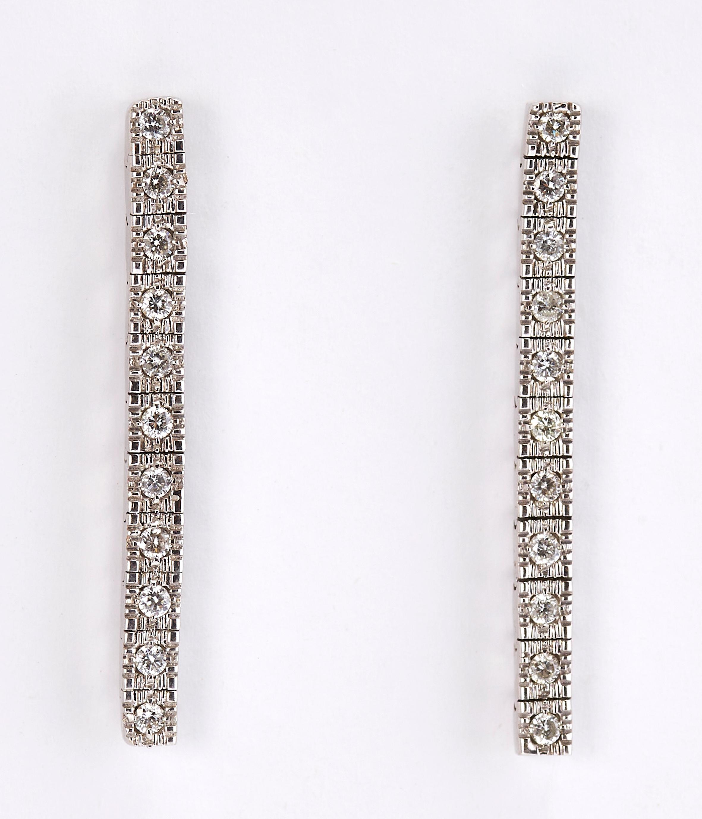 A Pair of 14 Karat White Gold Row Diamond Drop Earrings 

Elegant white gold row earrings, each earring has 11 round cut diamonds. The final touch for an evening look.
Total diamonds weight is 0.53 carat.
Total weight: 4.2 grams. 
