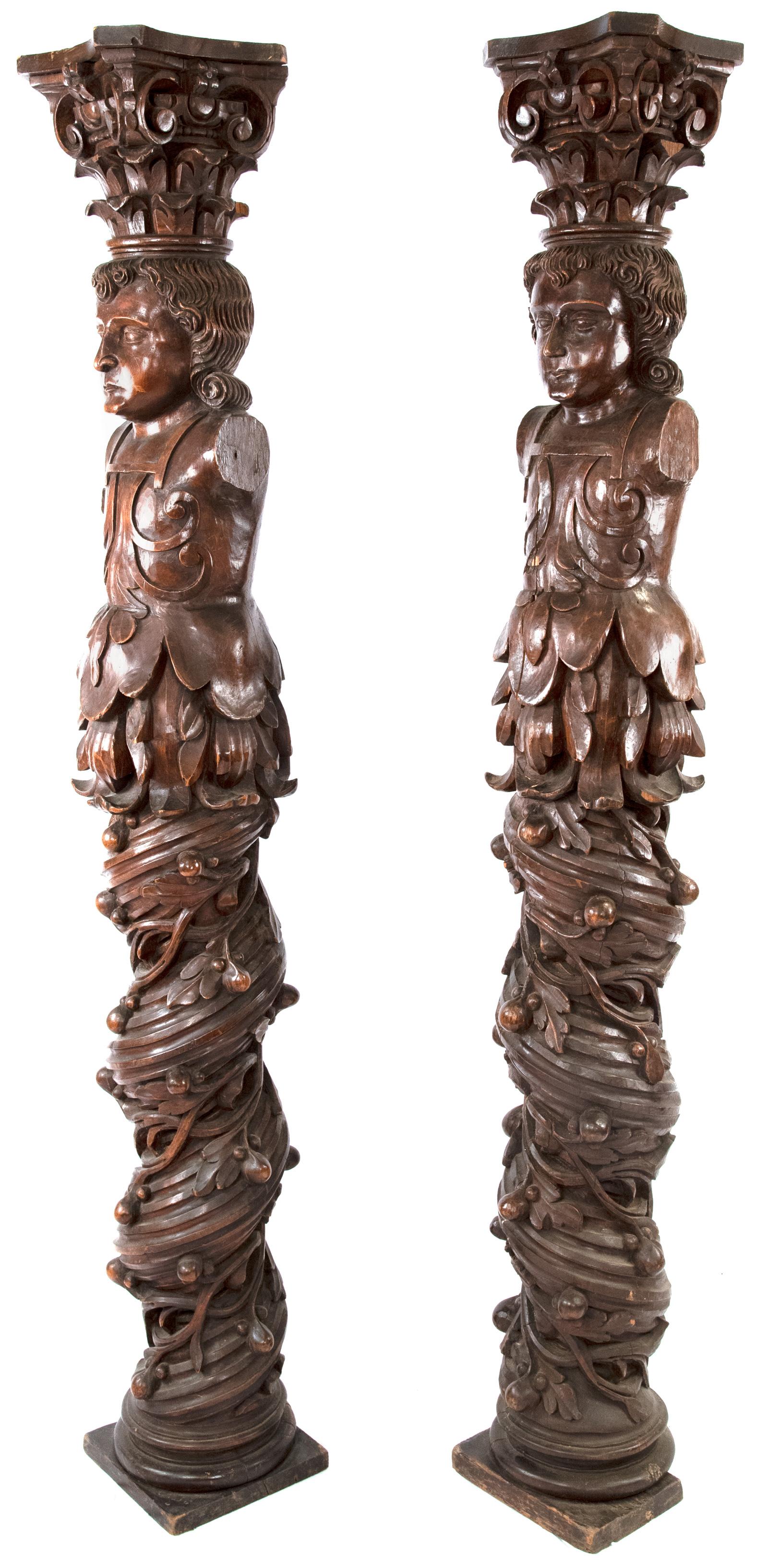 Two William & Mary carved English oak columns with Solomonic twisting and carved with full-relief fruit-and-leaf vines emanating from the base of court figures dressed in period costume. Each column is topped with elaborate Corinthian capitols. The