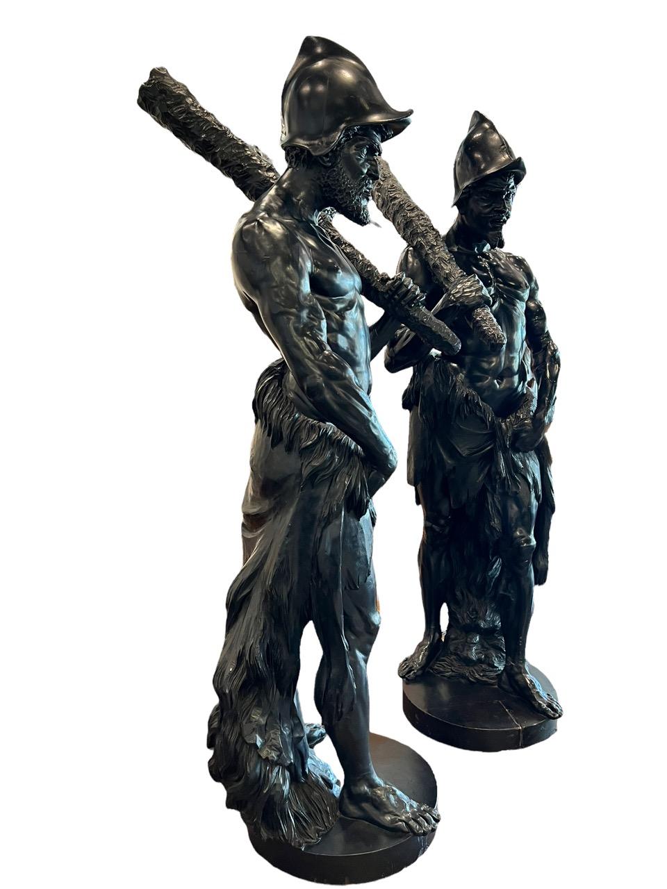 Behold an extraordinary pair of 17th Century Spanish ebonized wood sculptures that stand as a mesmerizing fusion of cultures and artistic mastery. These striking sculptures depict European soldiers adorned in the regalia of African tribal battle