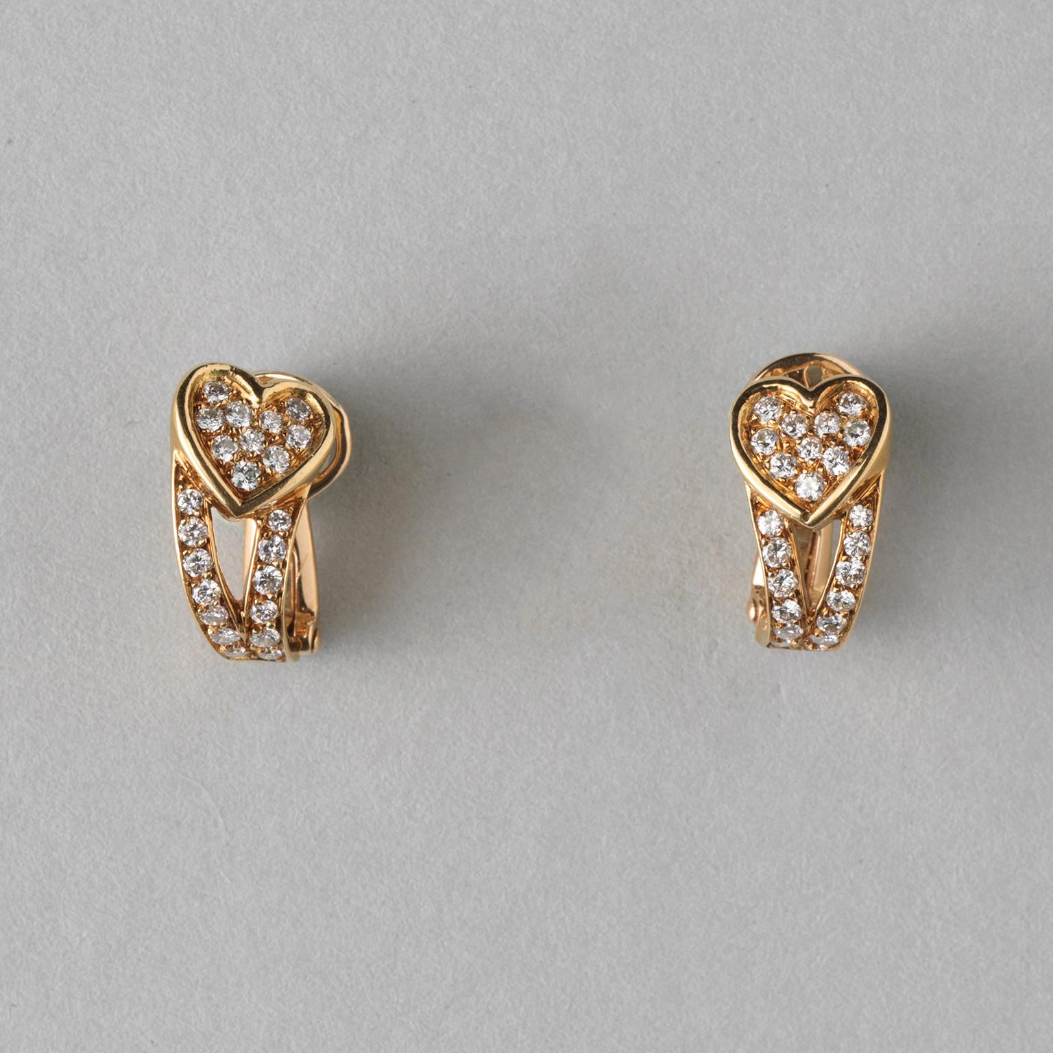 A pair of 18-carat yellow gold ear clips with a graceful heart, below which two bands run down and back, all fully set with brilliant-cut diamonds (approx. 0.92 carats total). Signed and numbered: Boucheron, 39229, circa 1960, in original