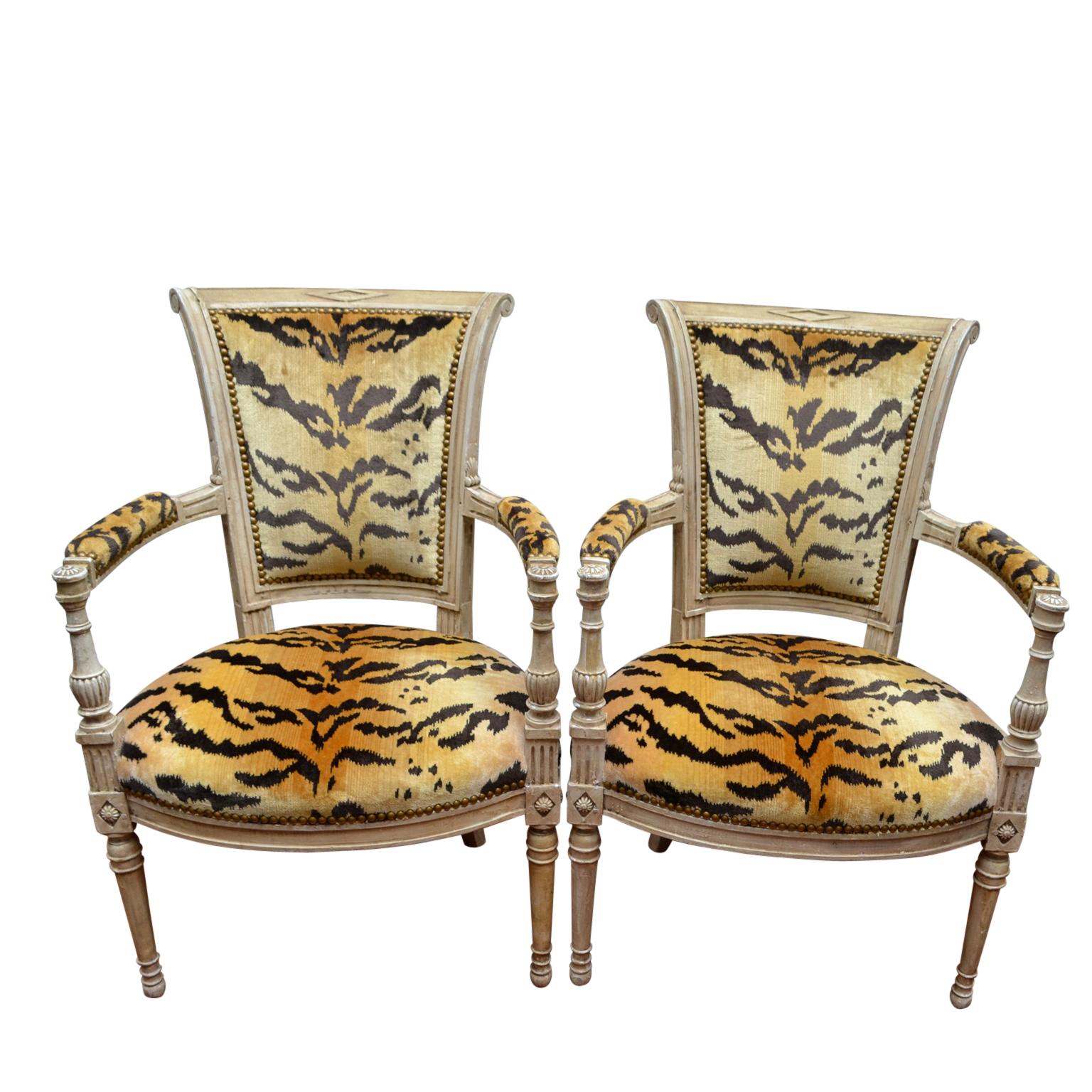 A pair of period 18th century painted Louis XVI open armchairs upholstered in modern tiger silk velvet.