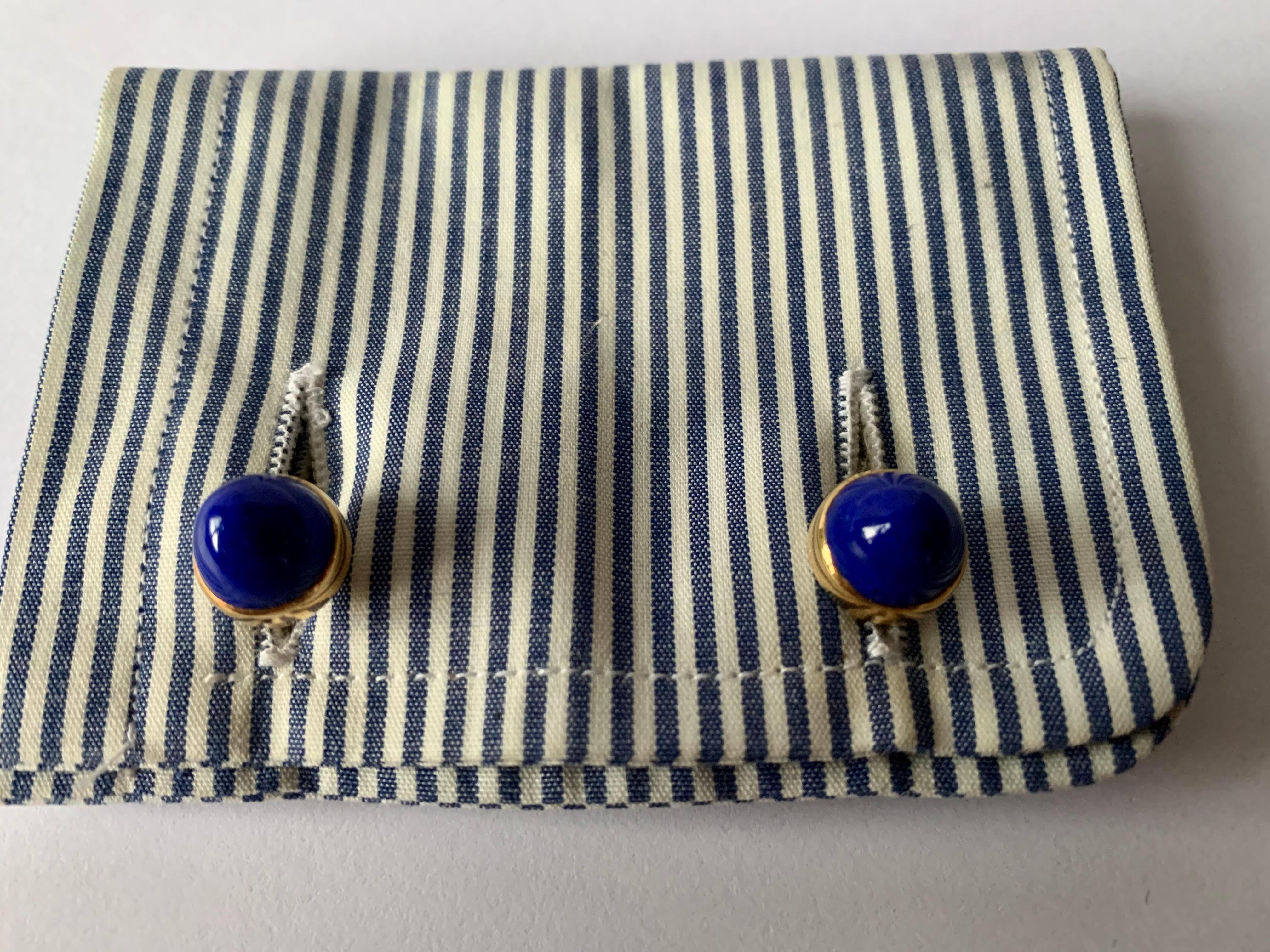 A pair of very attractive 18 K yellow Gold cufflinks with blue Enamel, 8 blue Sapphires weighing 0.70 ct and accentuated with 32 brilliant cut Diamonds weighing 0.30 ct. 
The back part of the cufflinks are 2 dome shaped Lapis Lazuli Cabochons.