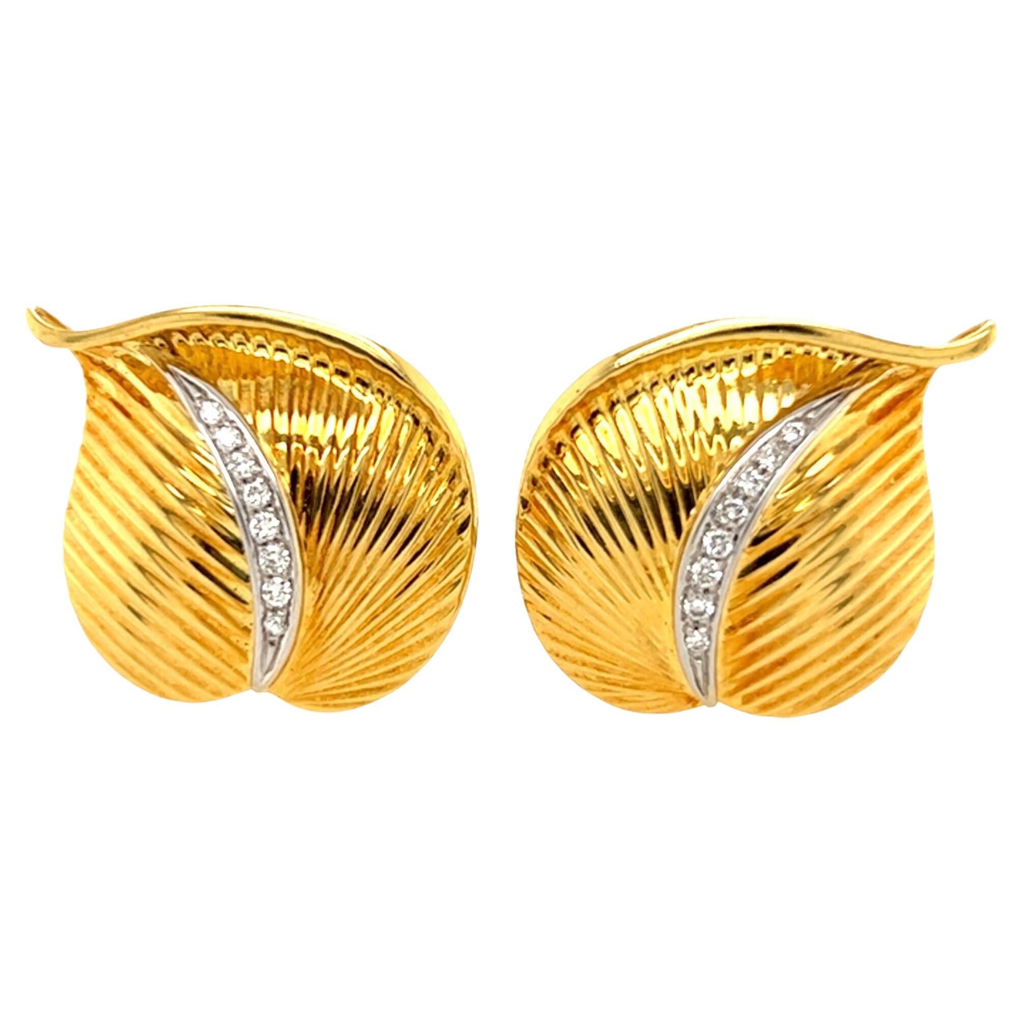 A pair of 18 karat yellow gold and diamond earrings. Italian, Designed as a leaf, enhanced by a pave set diamond stem. Length is approximately 1 1/8 inches, gross weight is approximately 12.1 grams. Stamped 18K Italy, 750, with Italian assay mark. 