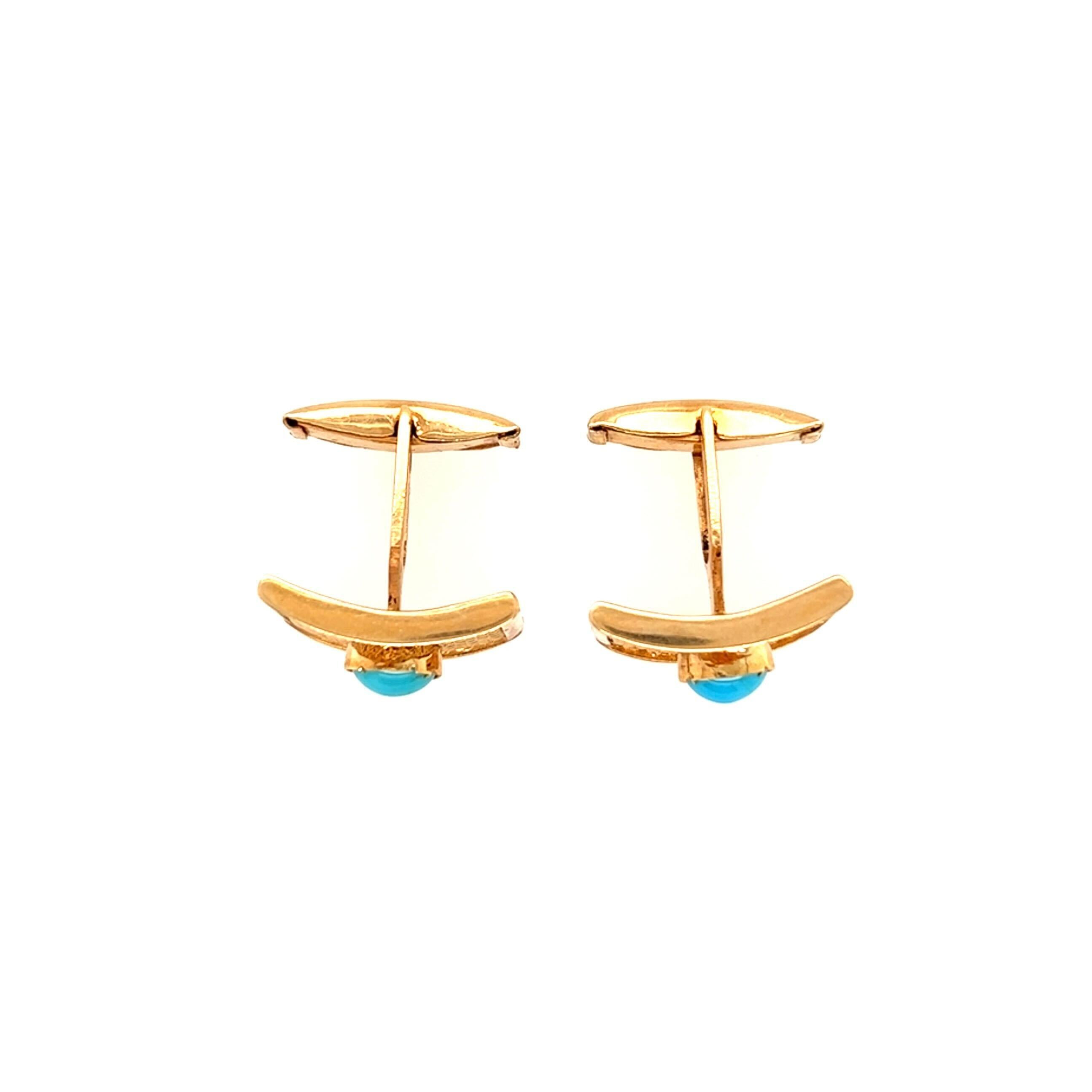 A pair of 18 karat yellow gold and turquoise cufflinks with swivel links. Circa 1970.  A 6x4mm turquoise cabochon is centered in a curved rectangular yellow gold woven mesh gold link within a gold frame.  Each link measures 20 x 14 mm.  Gross weight