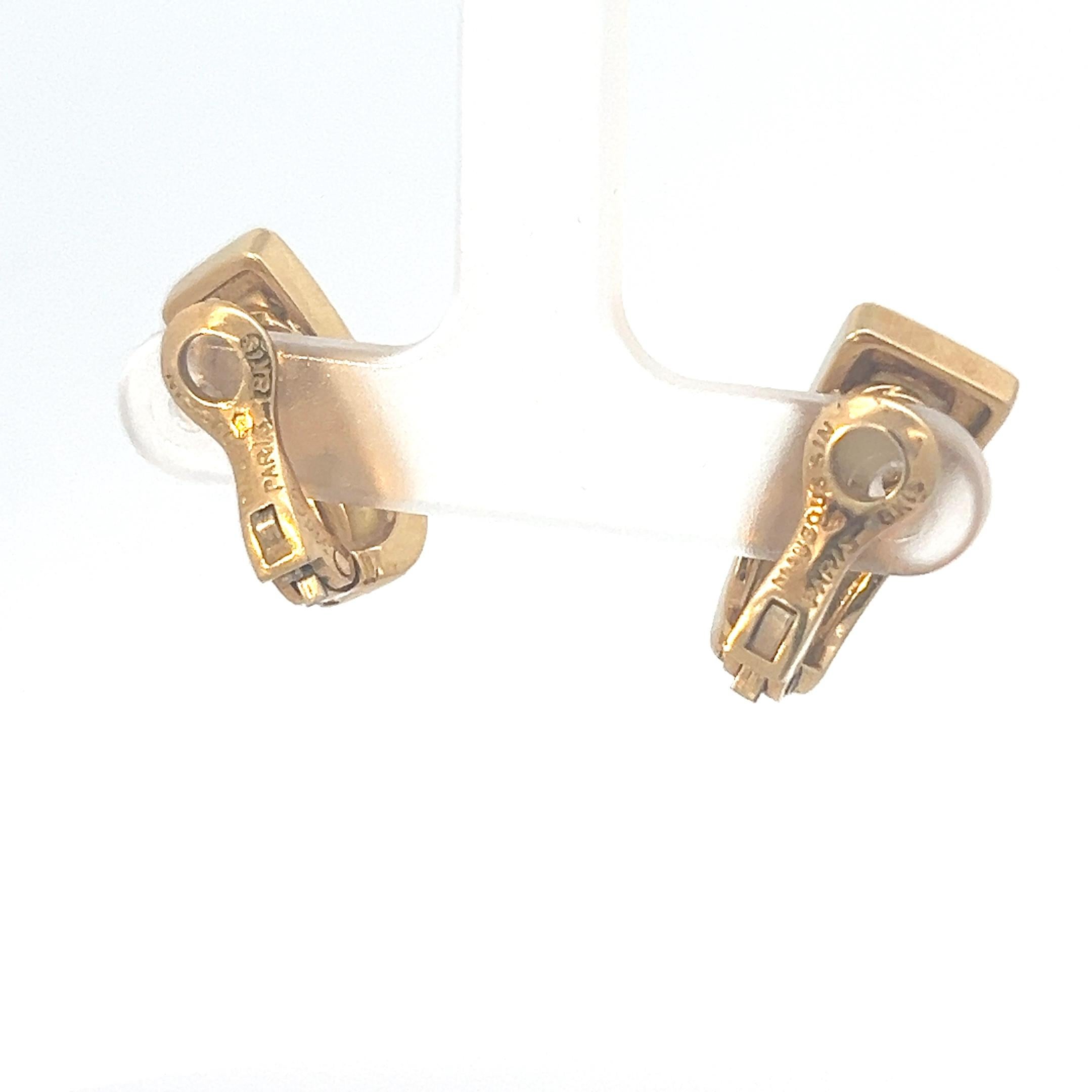 A pair of 18k yellow gold and Mother-of-Pearl ear clips by Mauboussin.

Origin: France.
Age: circa 1970.
Measurements: circa 1.8 cm long.
Weight: circa 8.8 grams together.
Hallmarks: Marked with the French hallmark for 18k gold.
Signed: Mauboussin