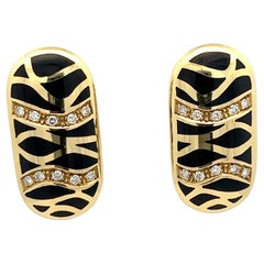 Retro A pair of 18k yellow gold, Diamond and black enamel ear clips by Illario.