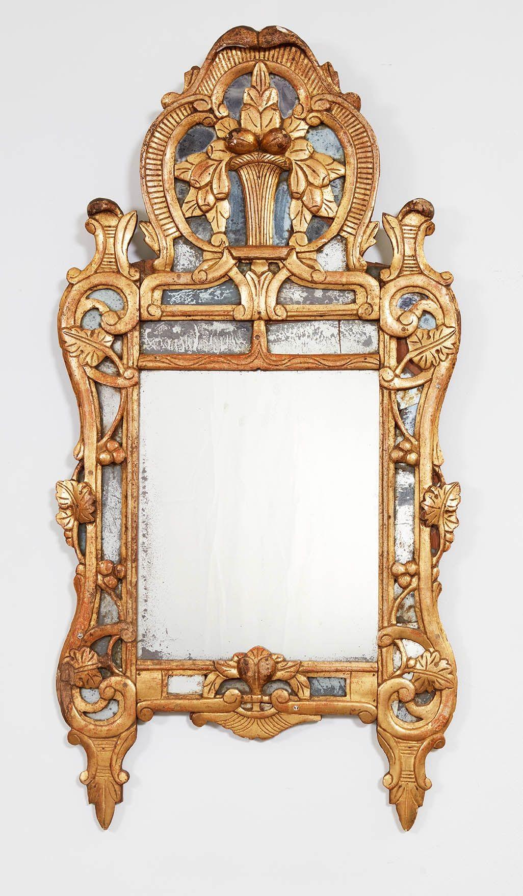 A pair of 18th century French giltwood and border glass mirrors having rectangular rococo frames surrounded by scroll and leaf decoration to borders and surmounted by elaborate crestings, with central plate and perimeter plates retaining beautifully